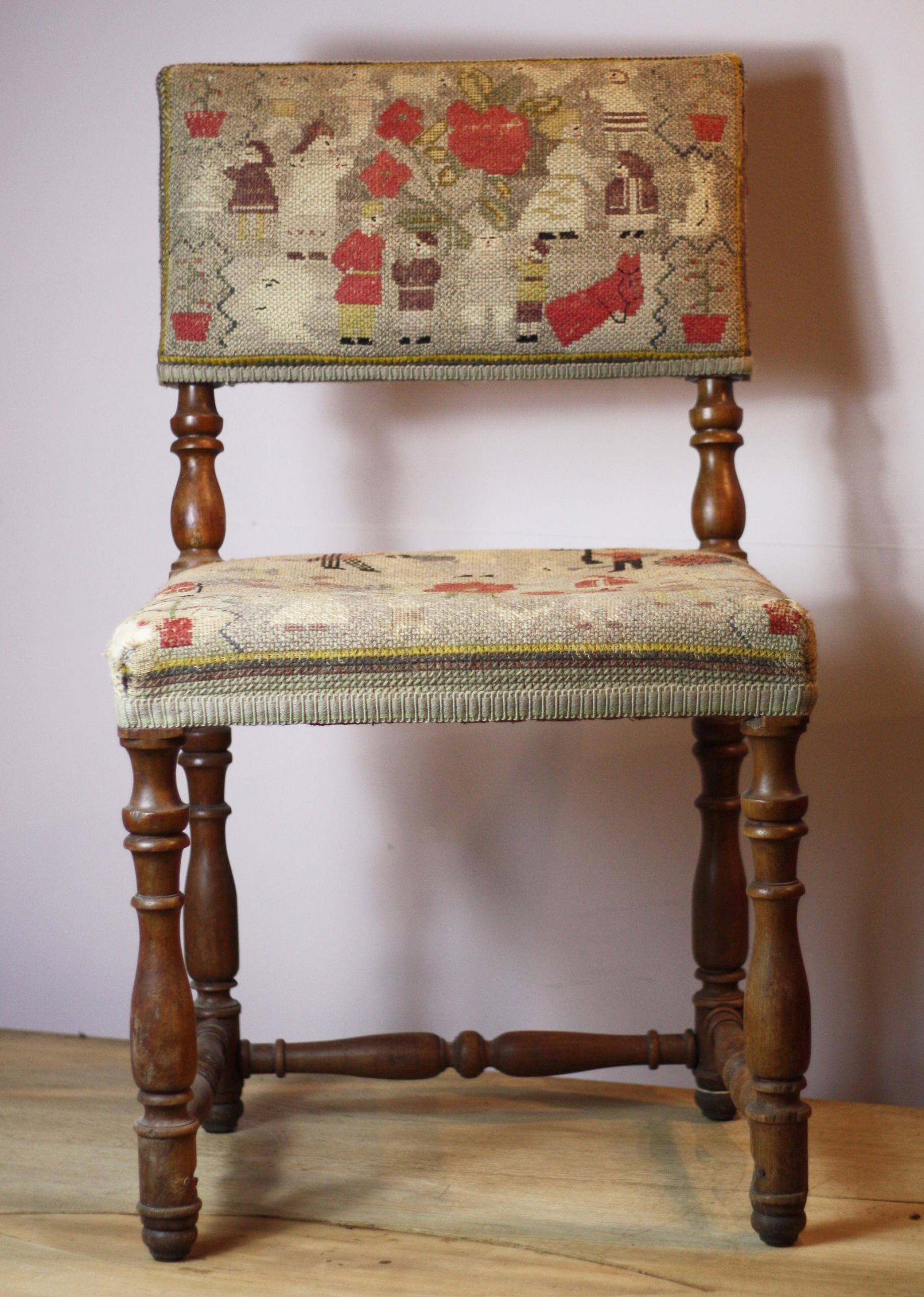 Pair of English country tapestry chairs, with naive depictions of people, animals and plants.