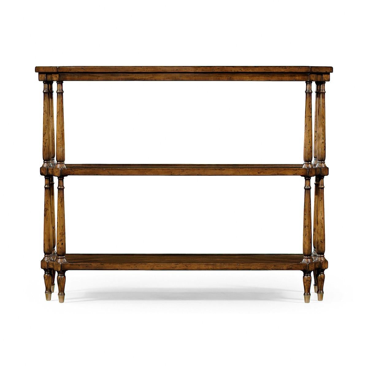 English country walnut console table with a wooden gallery, canted corners, six turned legs supporting three tiers, and raised on brass caster feet. Hand finished with a warm antiqued patina.

Dimensions: 48