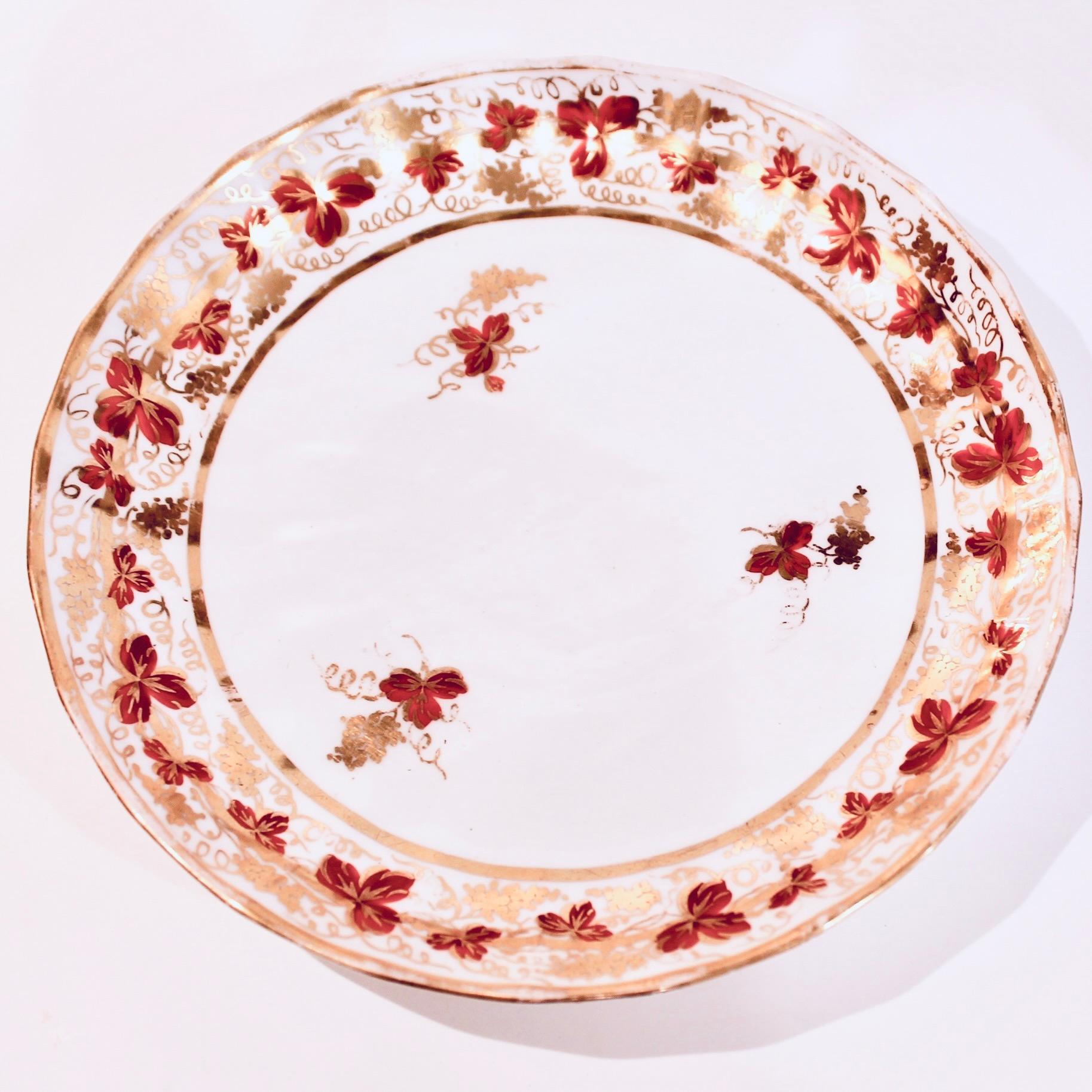 A fine pair of fine fluted red oxide and gilt decorated plates in a classic Derby pattern: a lively and dense yet delicate grapevine border. Light wear, rubbing to the gilding: slight on one, more noticeable on the other. Both with handpainted Derby