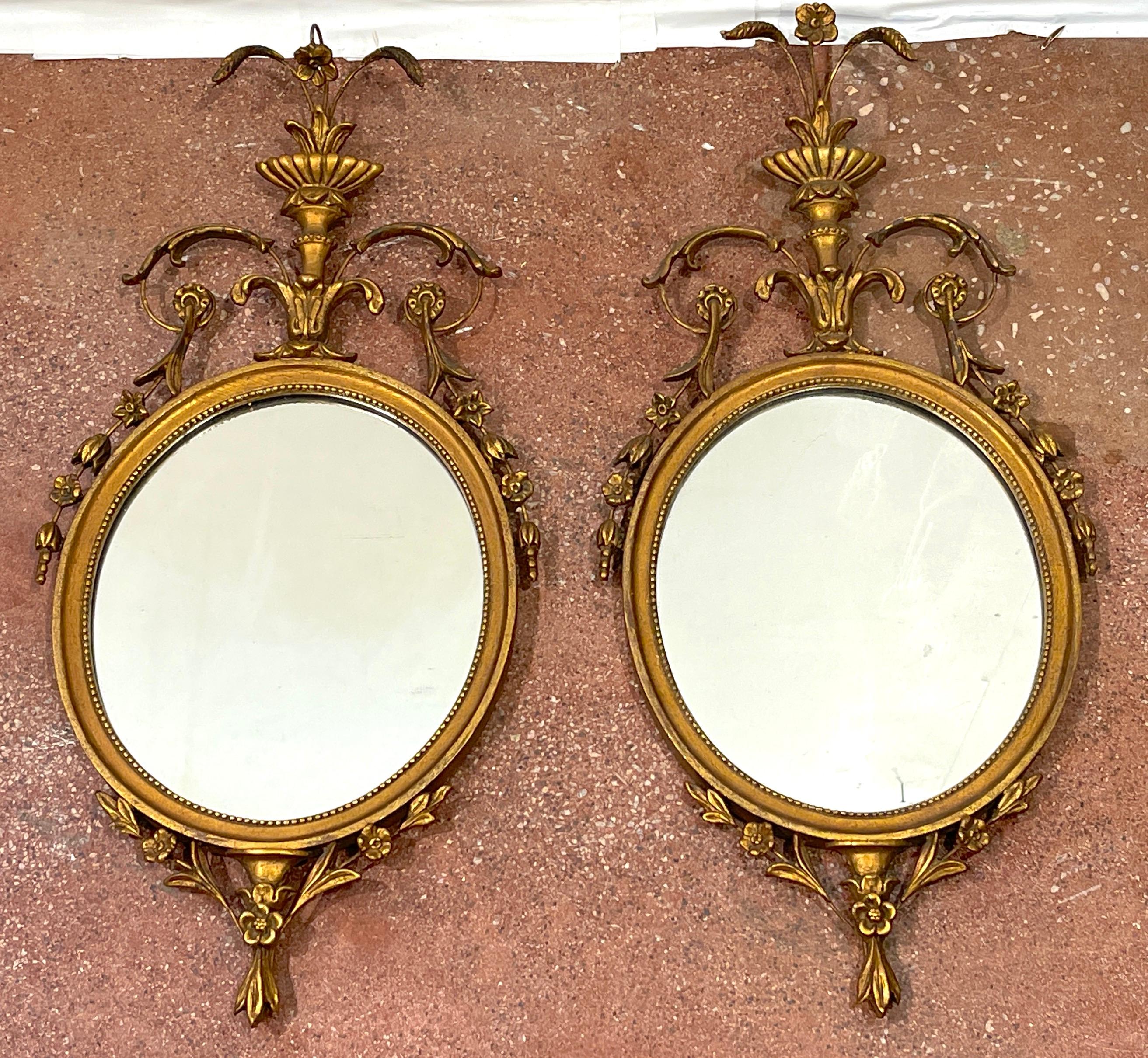 Pair of English Diminutive Georgian style giltwood mirrors, Circa 1900
Each one with floral urn finial and laurels, resting on oval giltwood frame holding a 11.5