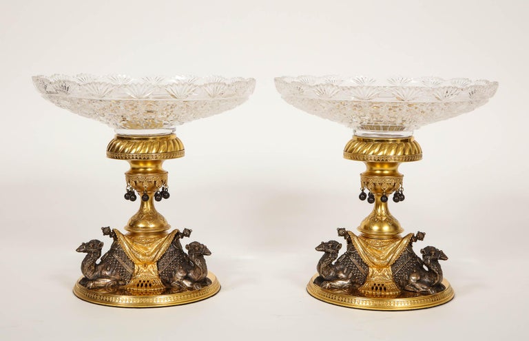 An unusual and very fine pair of antique ormolu and silvered bronze English camel centrepieces made for the Orientalist/Anglo Indian Market, Signed by Elkington. This magnificent pair of centrepieces denotes three beautifully silvered camels perched