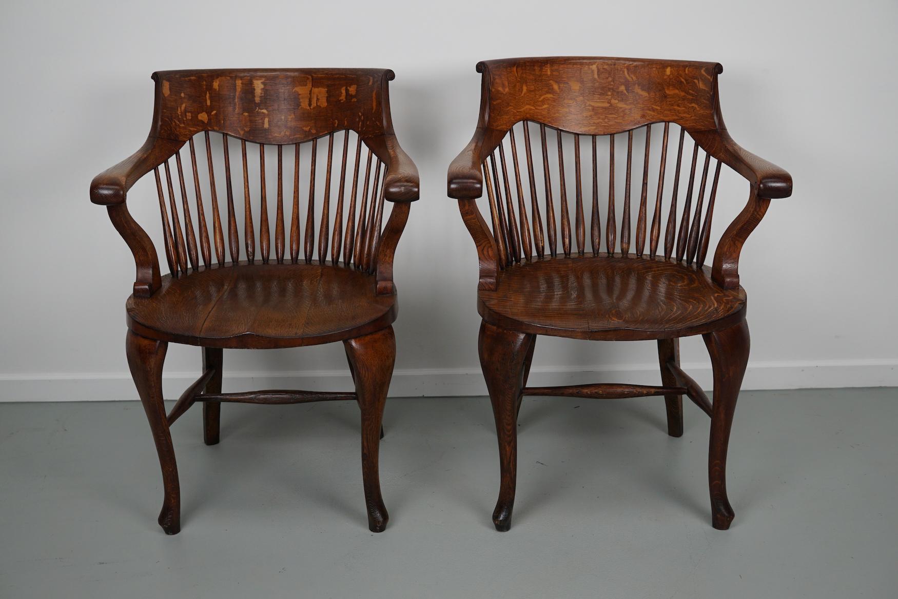 British Pair of English Edwardian Oak Spindle Back Captains Office Desk Chairs For Sale