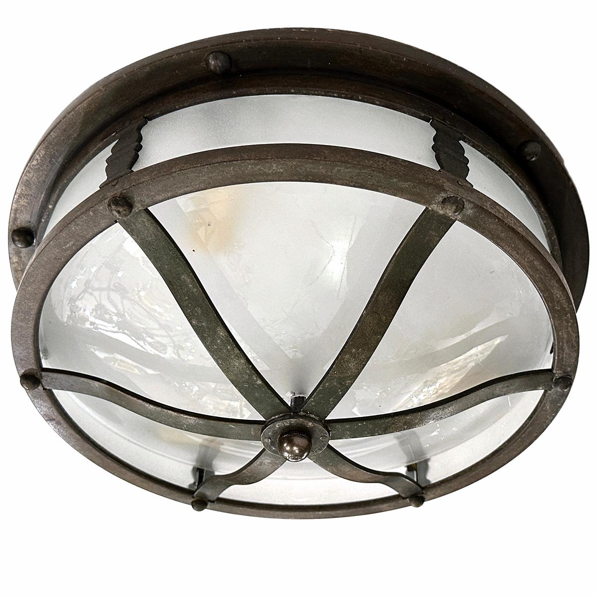 An English patinated bronze light fixture with frosted glass. 

Measurements:
Diameter: 14
