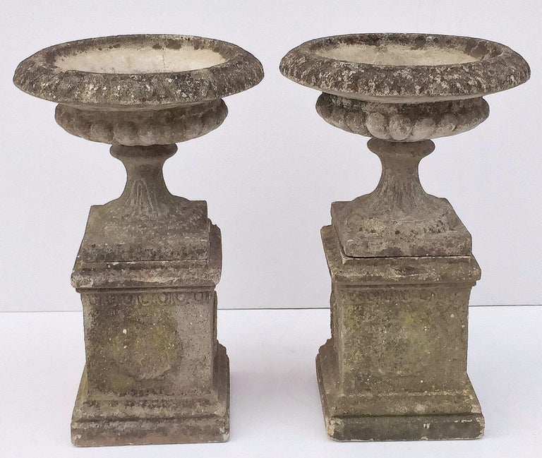 Pair of English Garden Stone Urns on Plinths with Garlands