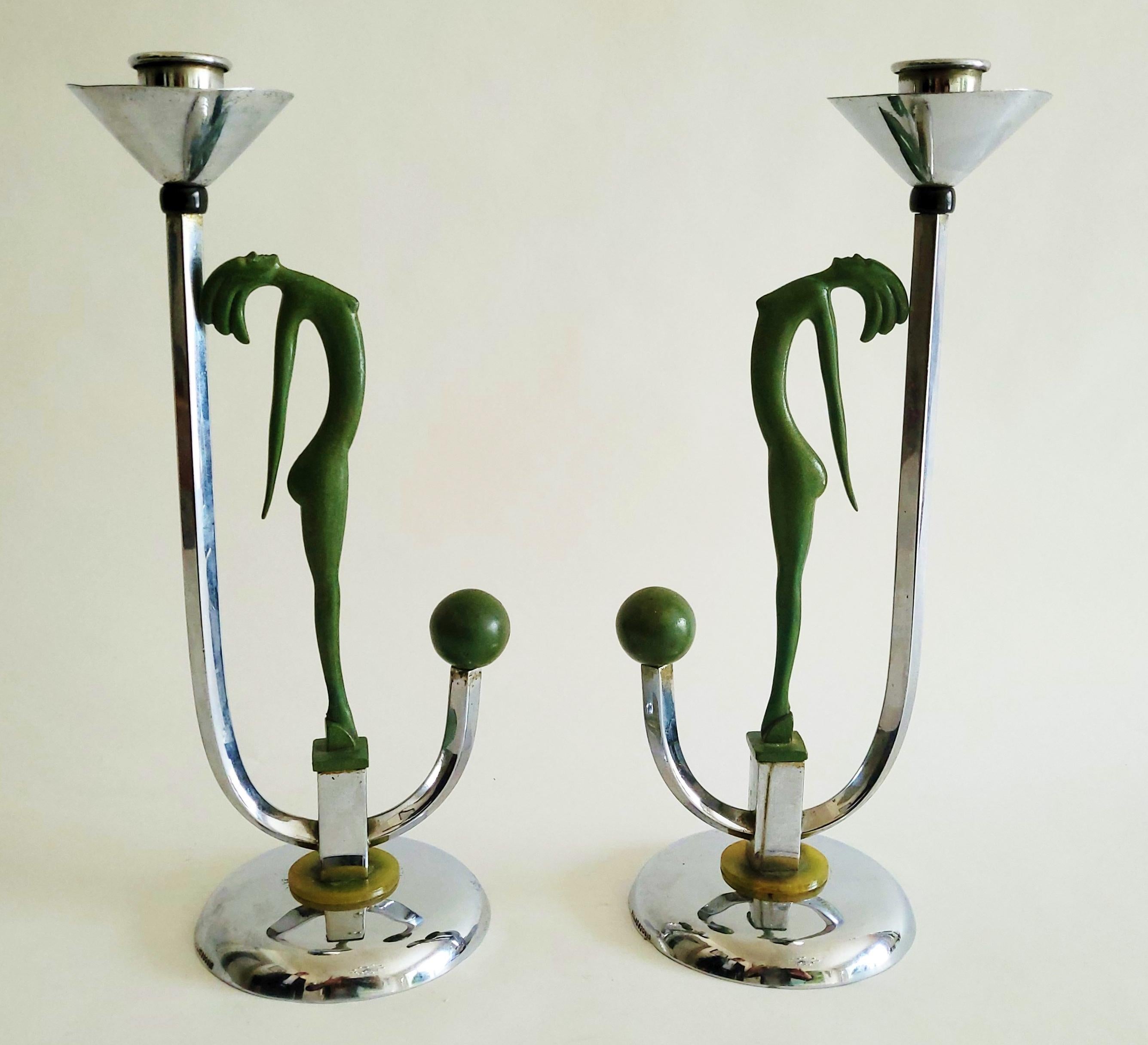 This magnificent pair of chrome and enameled English Art Deco candlesticks are part of a collection of designs for England's General Electric Company (GEC) each featuring a stylized nude created by the Austrian firm of Hagenauer. Ceiling lights wall
