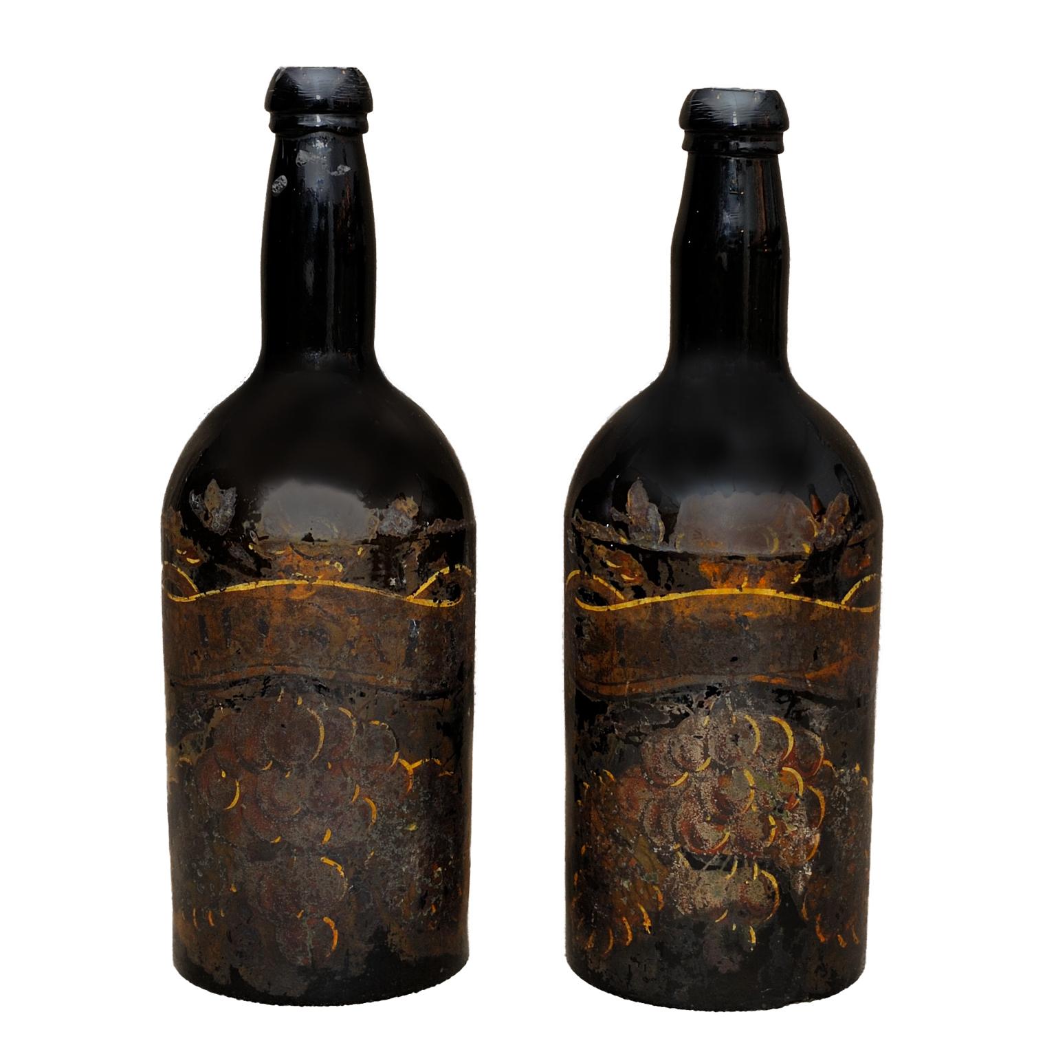 This is a beautifully decorative pair of large English late 18th century George III decorated wine bottles, circa 1780.

They would make fine water carafes or perhaps lamp bases.