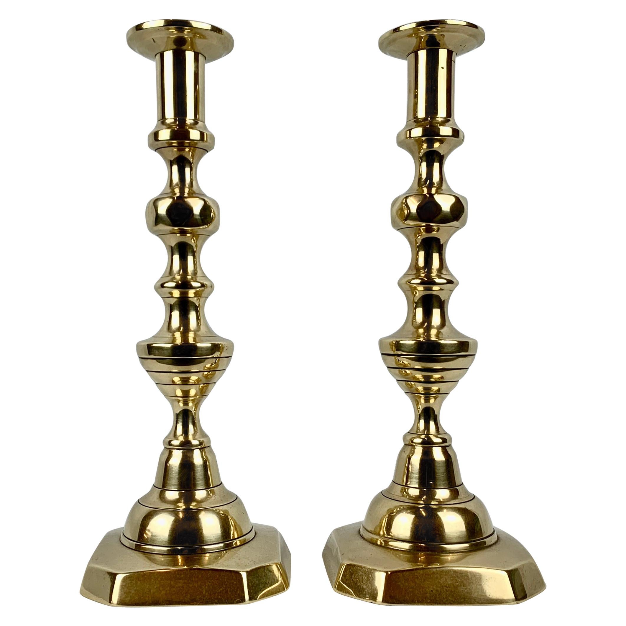 A Pair of Diamond and Beehive Push-Up Brass Candlesticks, 12" England, 19th c.