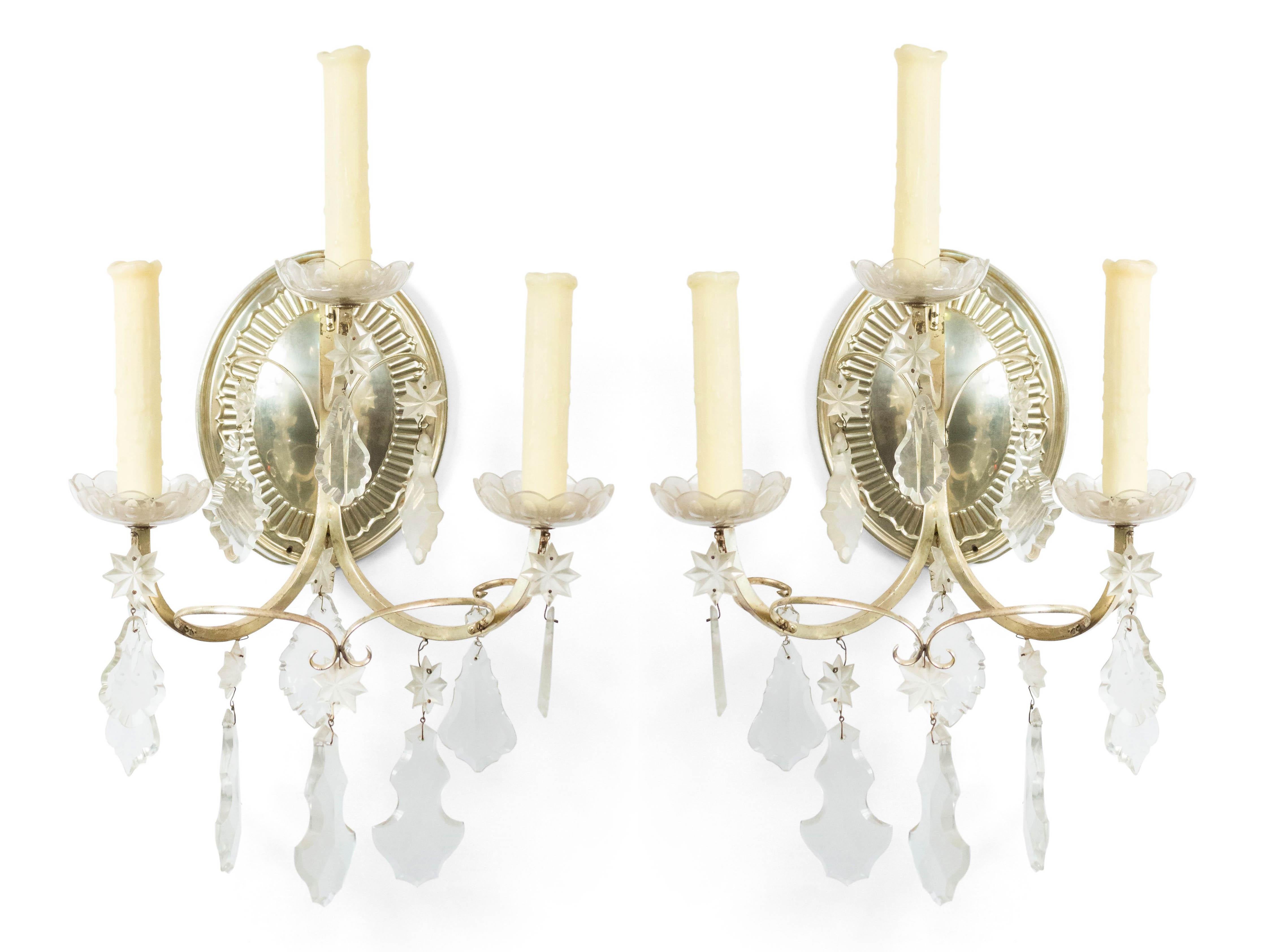 Pair of English Georgian style (19/20th Cent) silver plate and crystal 3 scroll arm wall sconces with oval fluted back.

