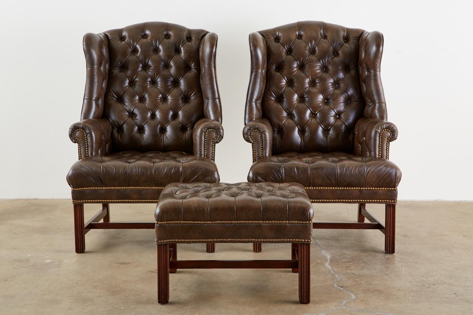 American Pair of English Georgian Style Tufted Leather Wingbacks with Ottoman