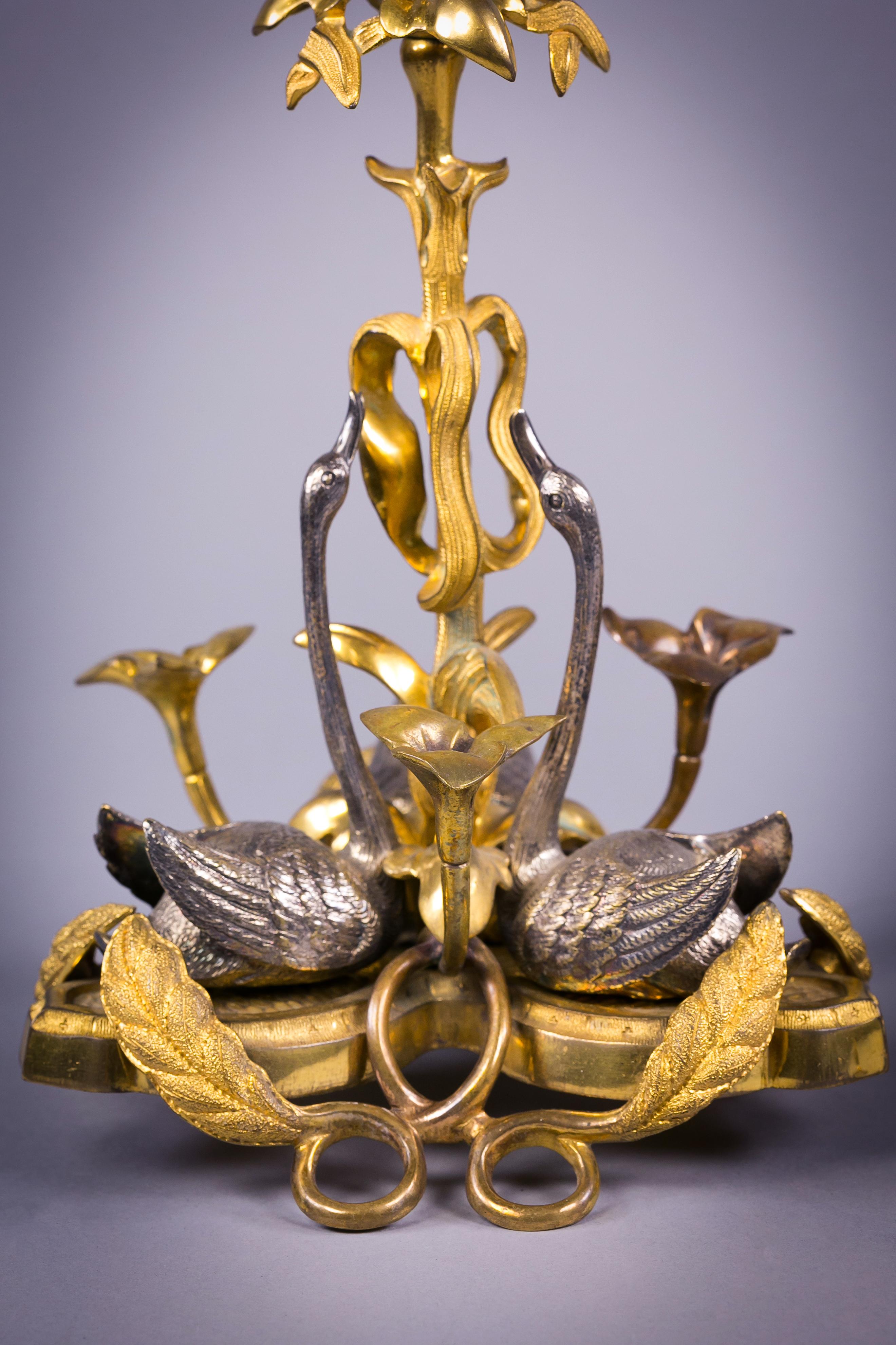 Pair of English gilt and silvered bronze swan candlesticks, circa 1830.