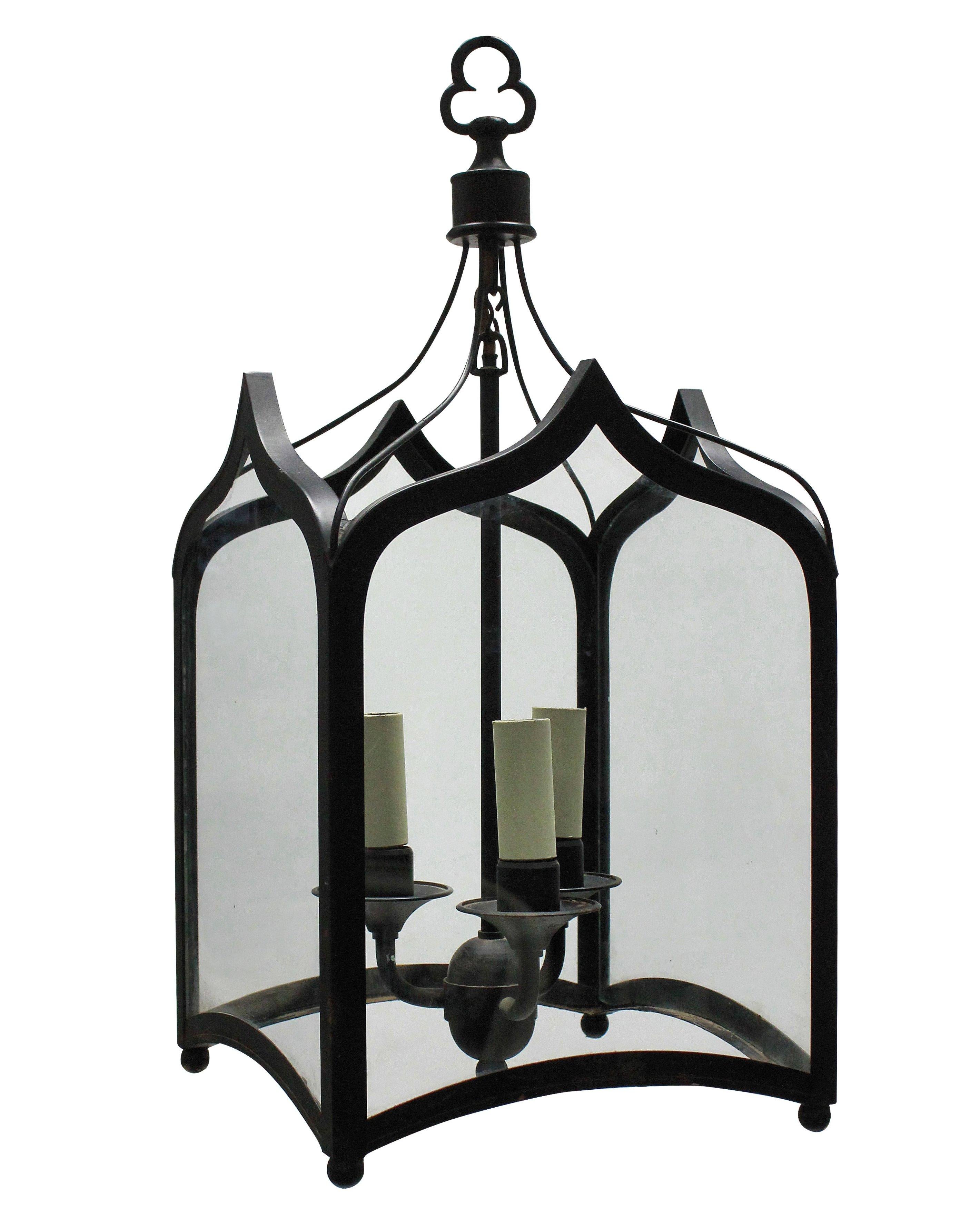 A pair of English Gothic hanging lanterns in painted wrought iron, each with three lights.