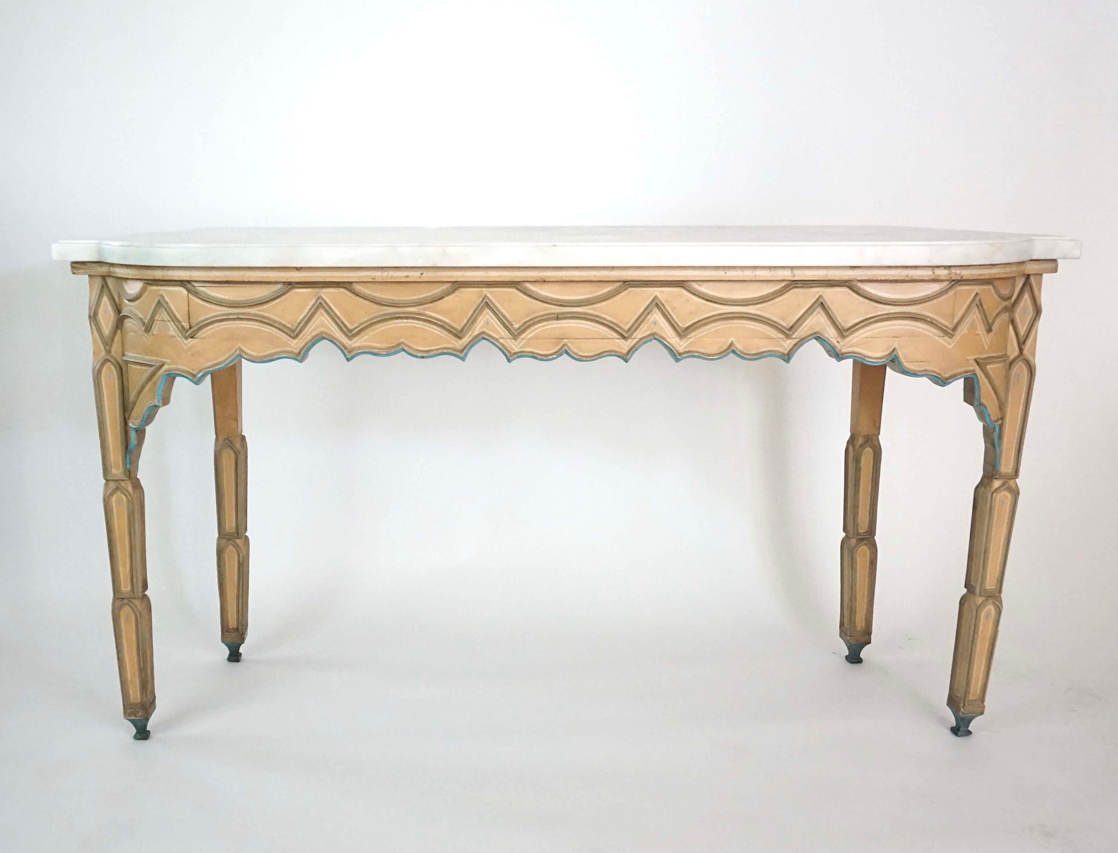 A highly unusual and chic pair of circa 1840 French Troubadour 'Gothic' style console side tables having convex isosceles trapezoid or trapezium form rounded breakfront Carrara marble tops on corresponding shaped bases painted in shades of 'pink