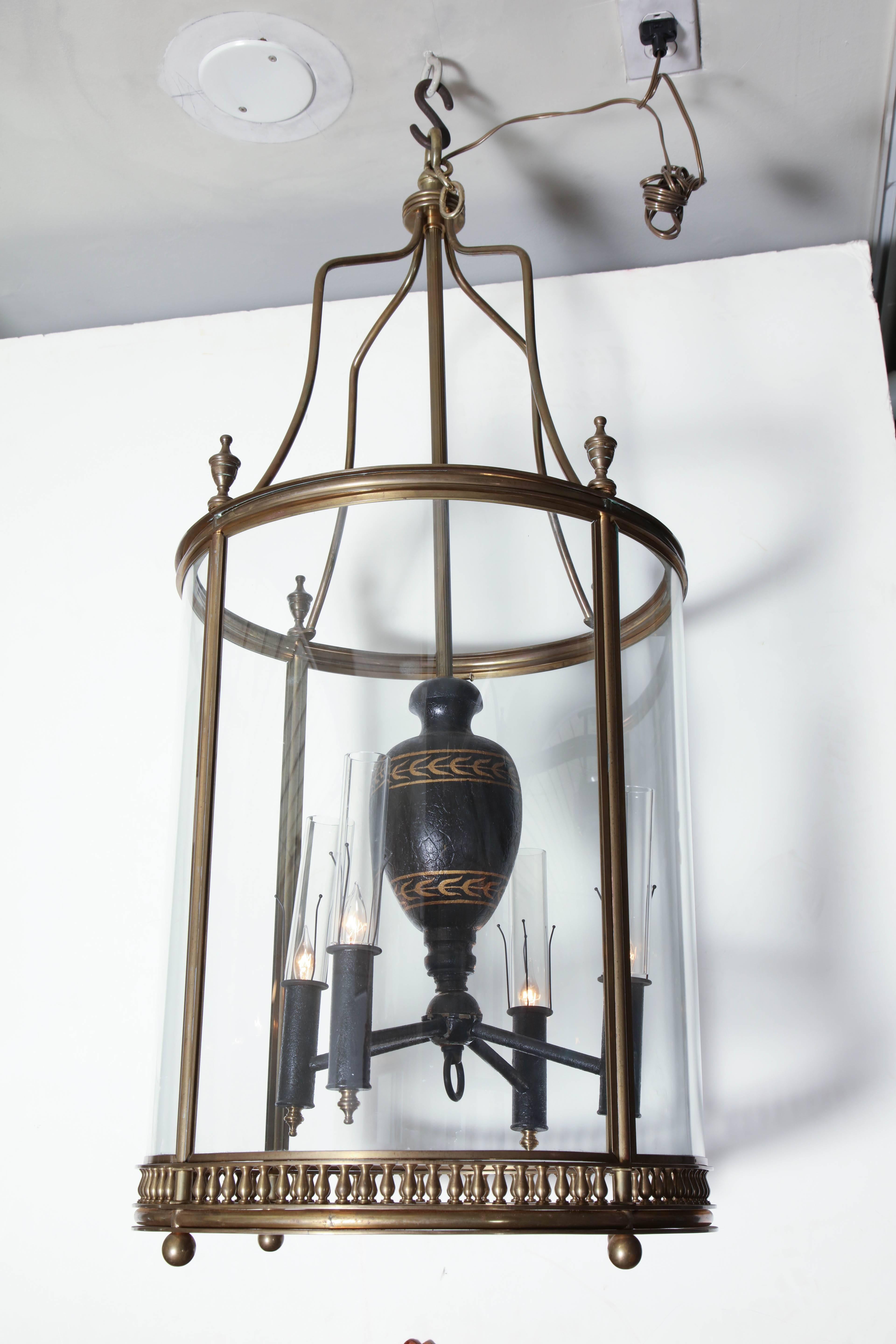 Pair of English brass four-light hall lanterns of cylindrical form with urn form finials.