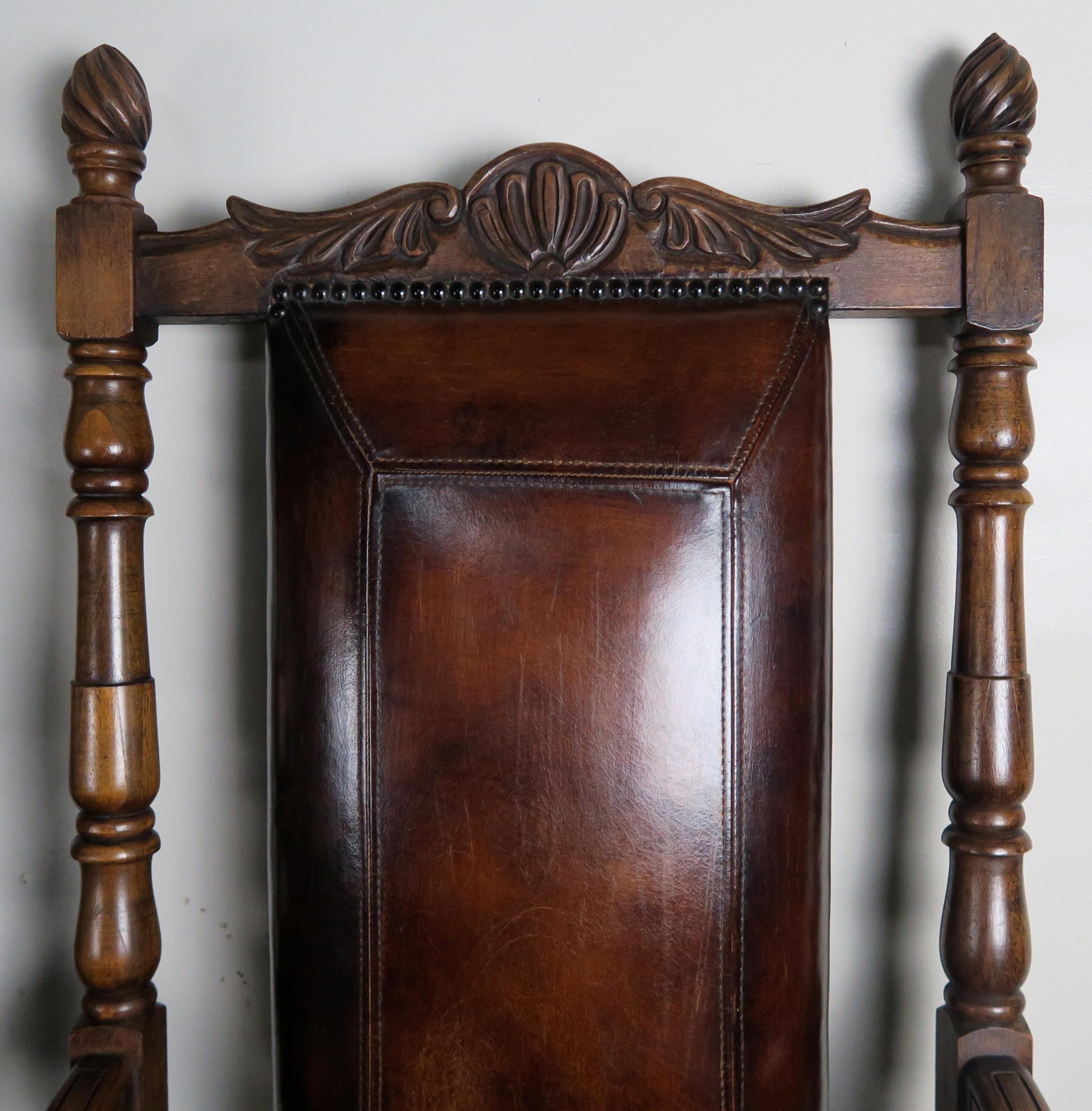 Pair of monumental English leather mahogany armchairs. Baseball stitching on leather upholstery.