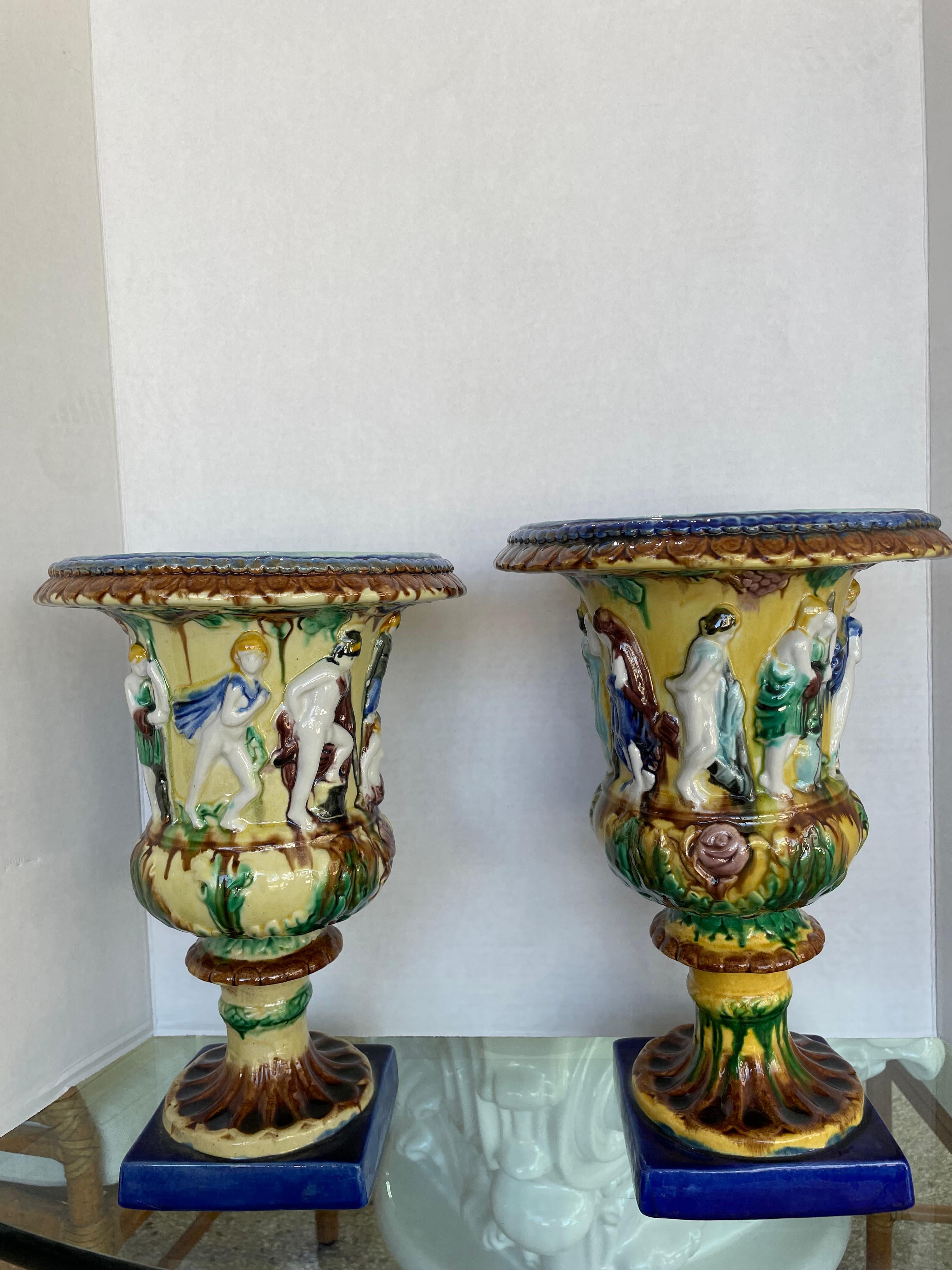 This stylish pair of English majolica glazed urns are very much the pieces coveted by the American decorator Mario Buatta. 

Note: dimensions of one urn are 12.75