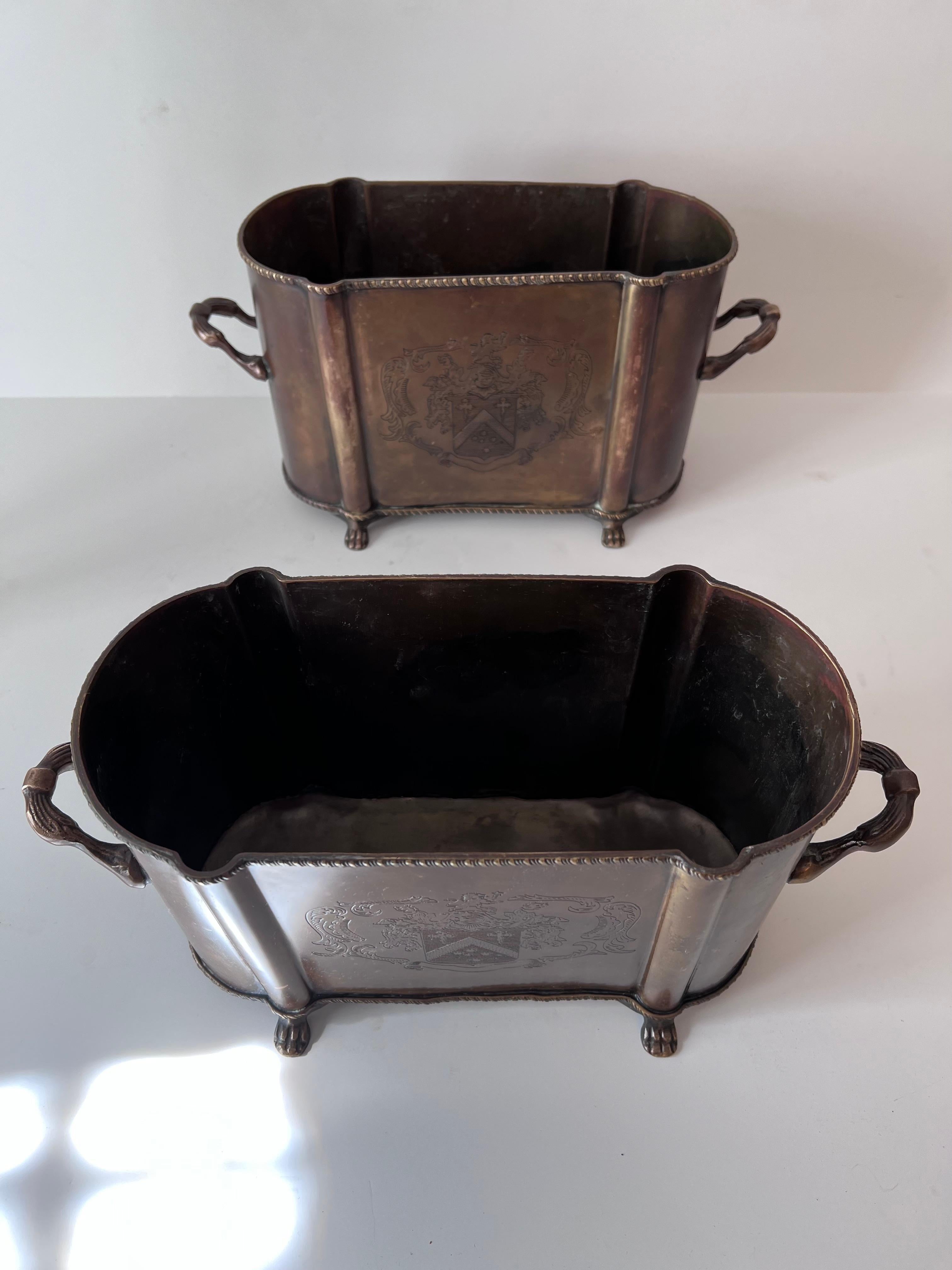 Pair of English Metal Cachepots or Jardinieres with Claw Feet and a Crest from 6