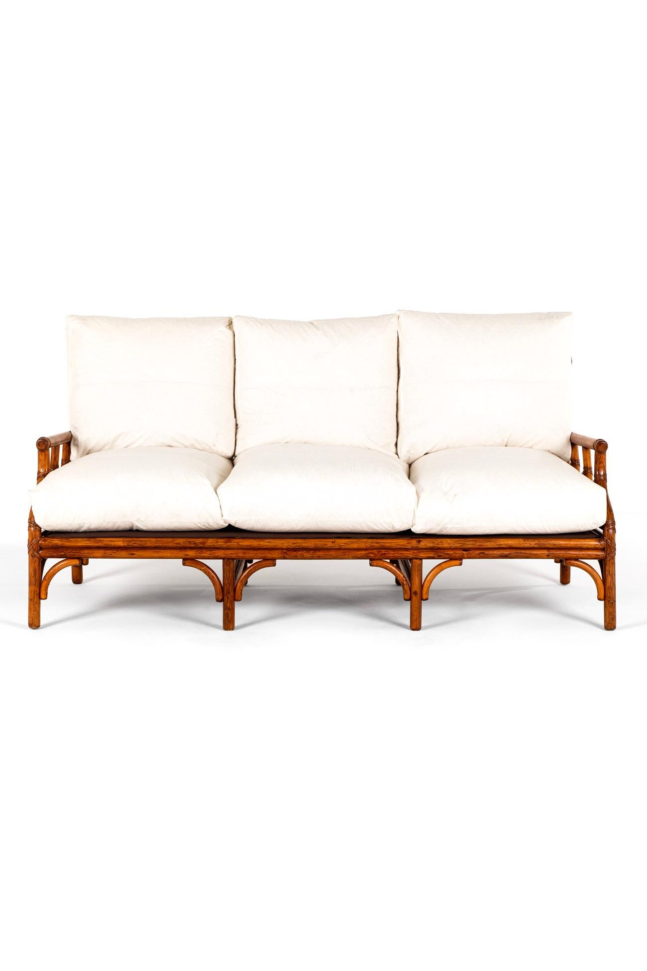 A wonderful pair of faux bamboo sofas in pine arranged as a three seater and a generous two seater sofa.

The curved and tapering backs are supported with an arrangement of interlocking supports with secure bindings to each joint forming a geometric
