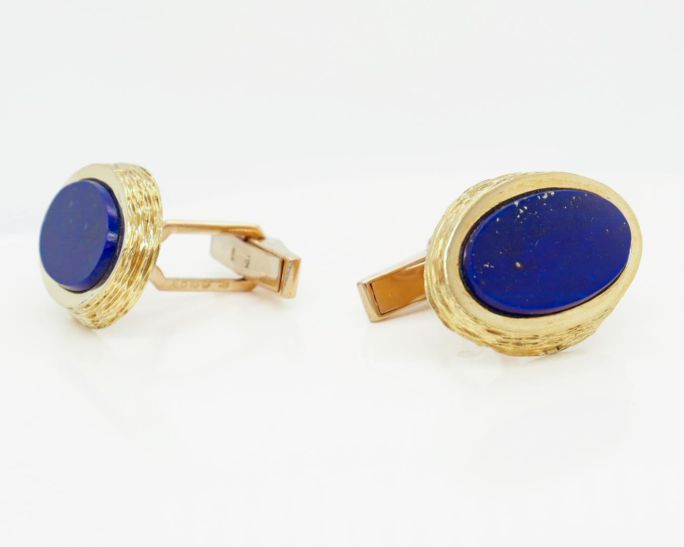 A fine pair of English Modernist cufflinks.

By Kutchinsky, the renowned London jewelry house.

In 18k gold and set with flat oval lapis cabochons.

Marked for 1970, a period in which Joseph Kutchinsky was at the height of his design