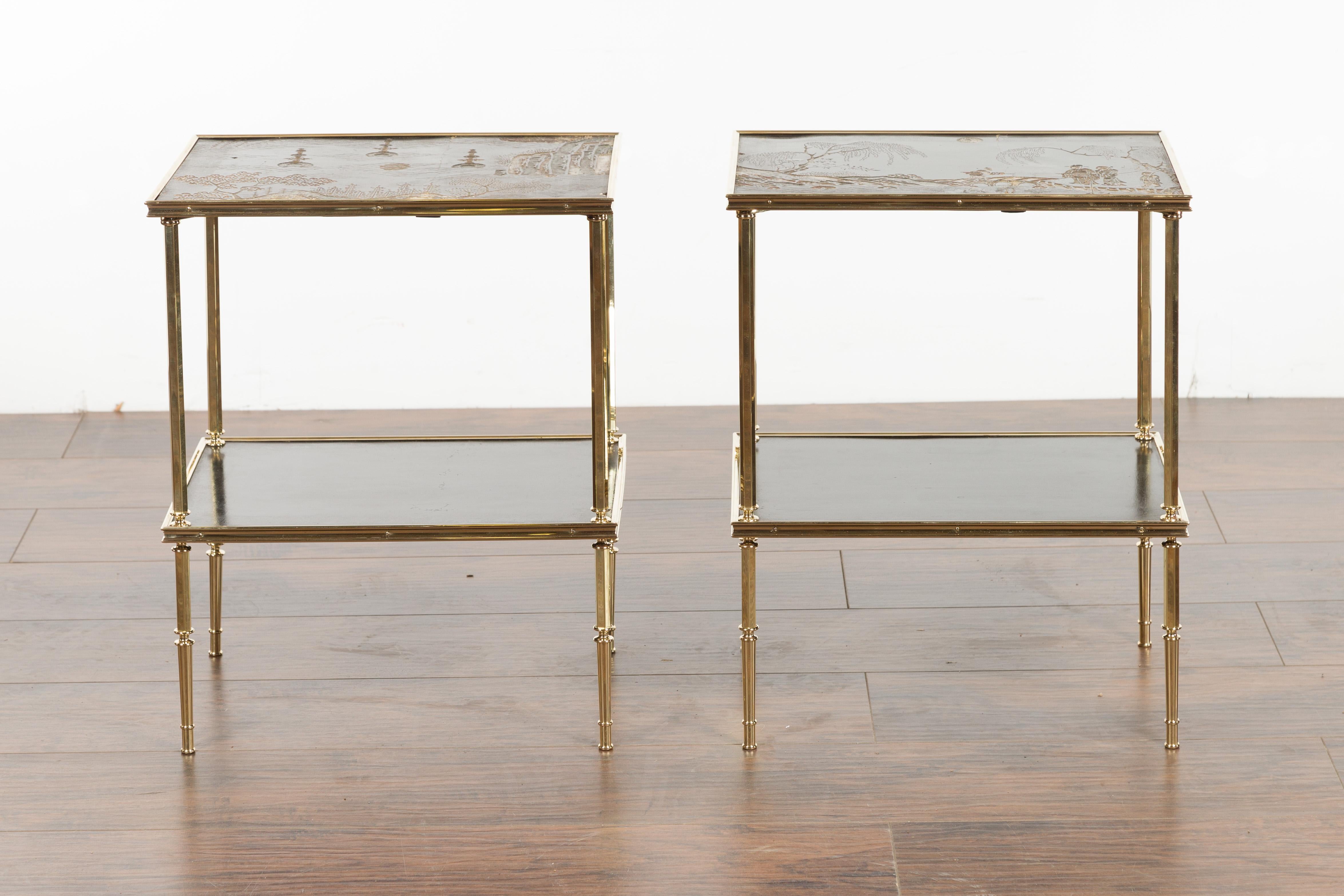 A pair of English vintage brass side tables from the mid 20th century, with Chinoiserie tops and lower shelves. Created in England during the midcentury period, each of this pair of side tables features an exquisite Chinoiserie top with Chinese