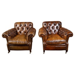 Pair of English Midcentury Tufted Leather Club Chairs with Nailheads and Casters