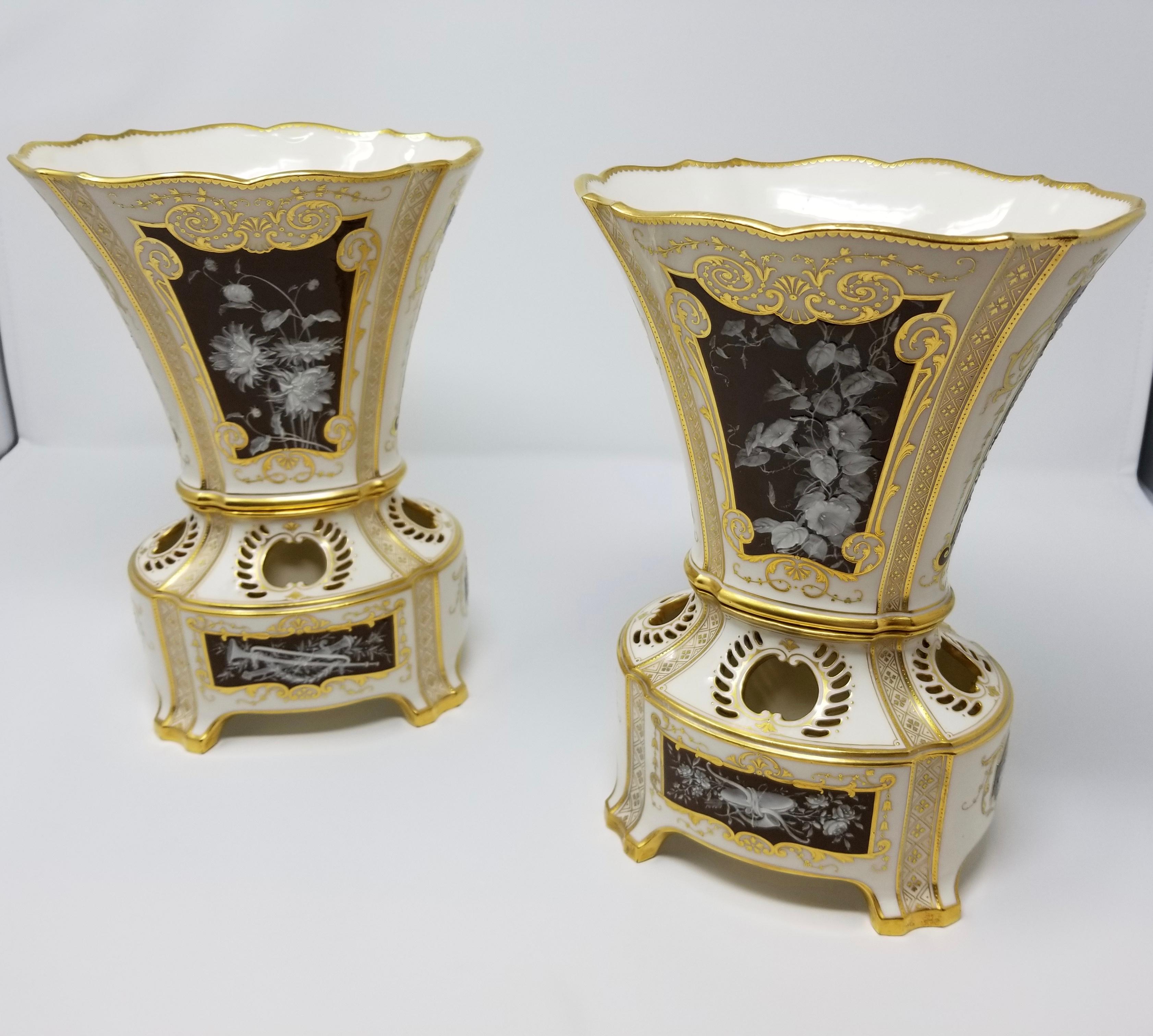 A beautiful pair of English Mintons olive-brown and white pate sur pate vases with 12 total pate sur pate panels, signed AB for Albion Birks. Each of the 12 panels depicts a different subject. Two panels depict putti playing with each other in a