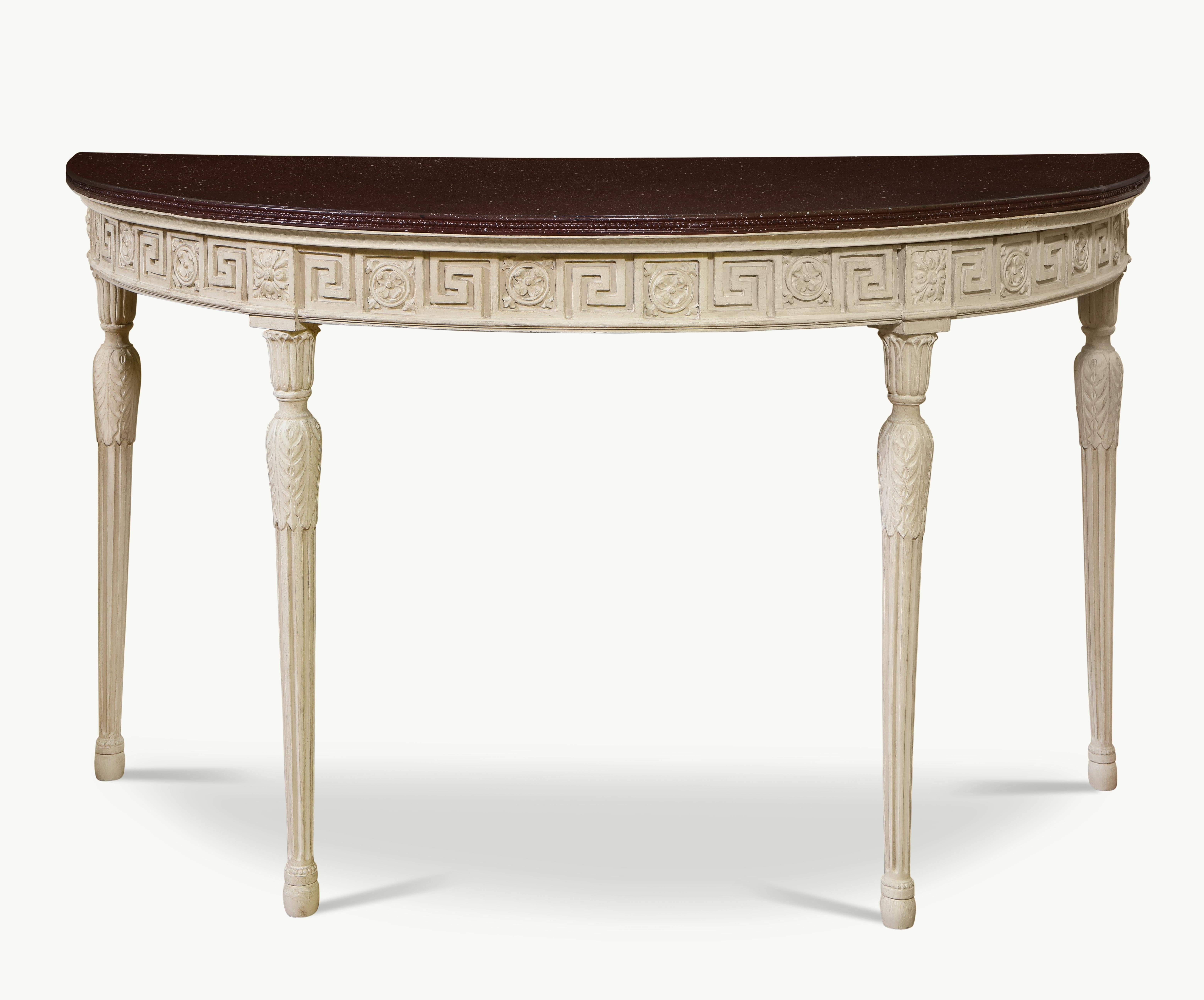 Each top painted in faux porphyry with beaded edge; over a white-painted base with Greek key and rosette carved frieze, raised on turned tapering stop-fluted legs wrapped with acanthus leaves and headed by foliate capitals.
