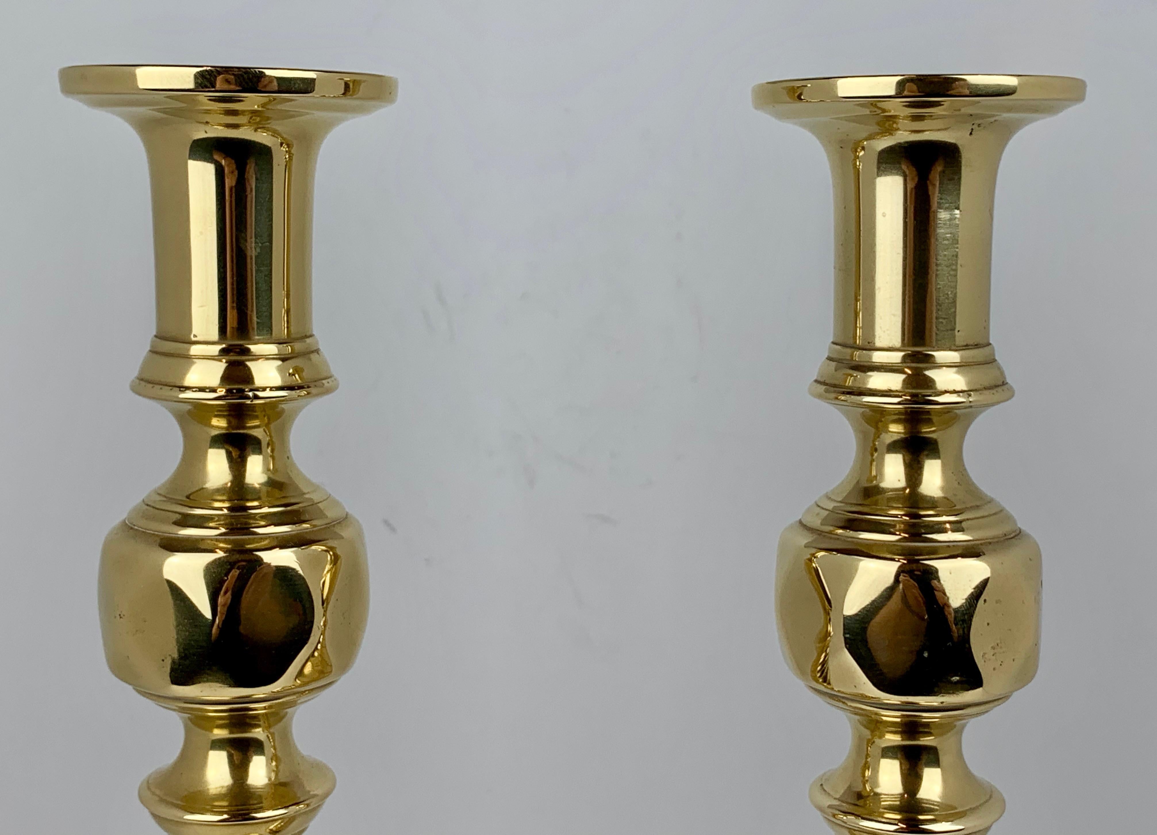 A pair of 19th century English brass push-up candlesticks. If you look closely at the photos you will see that their English registered marks match, which is very important for this tells us they were made as a pair. The push-up mechanism is intact