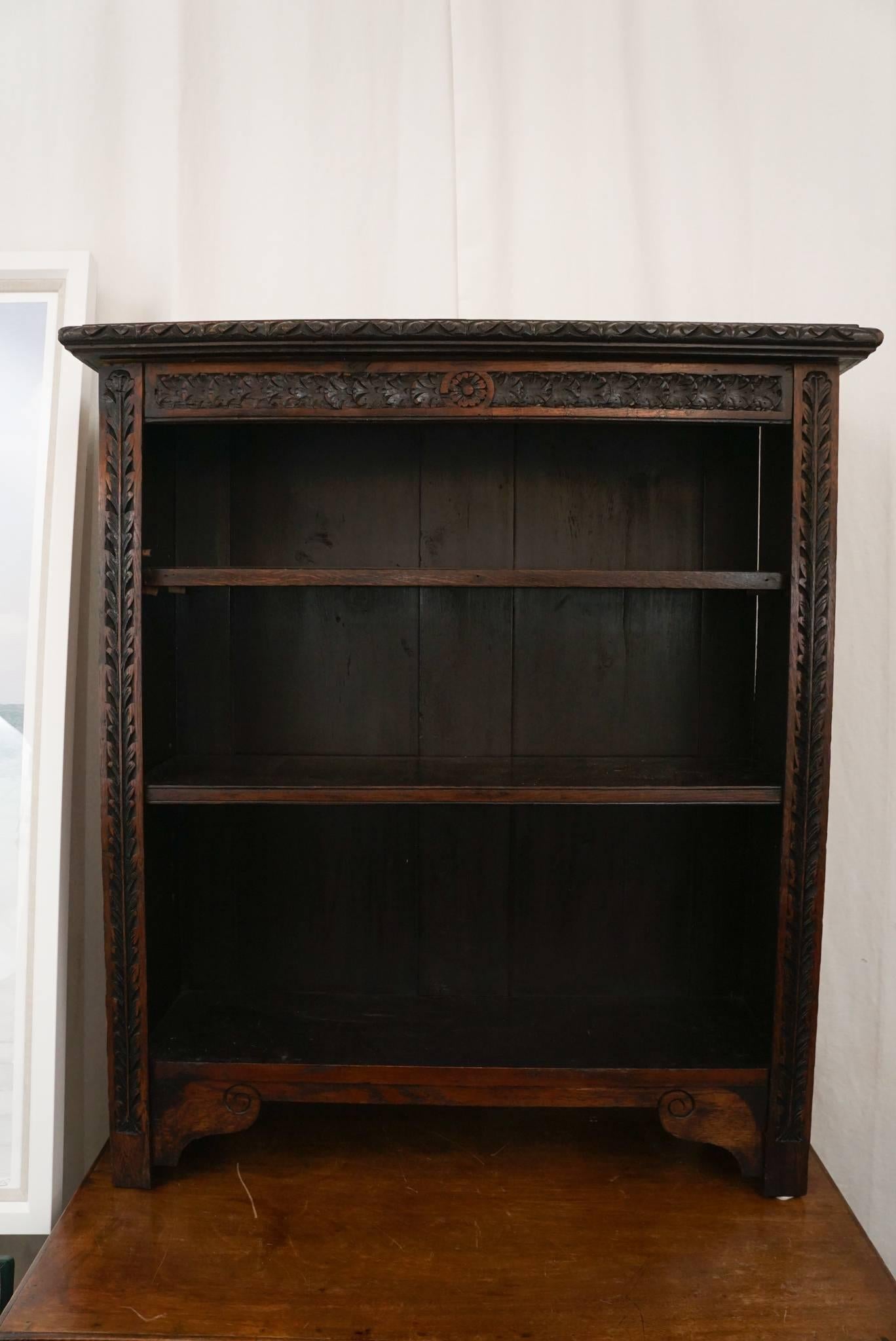 A wonderful pair of English, oak carved bookcases with three shelves.
One stationary shelf, two adjustable.