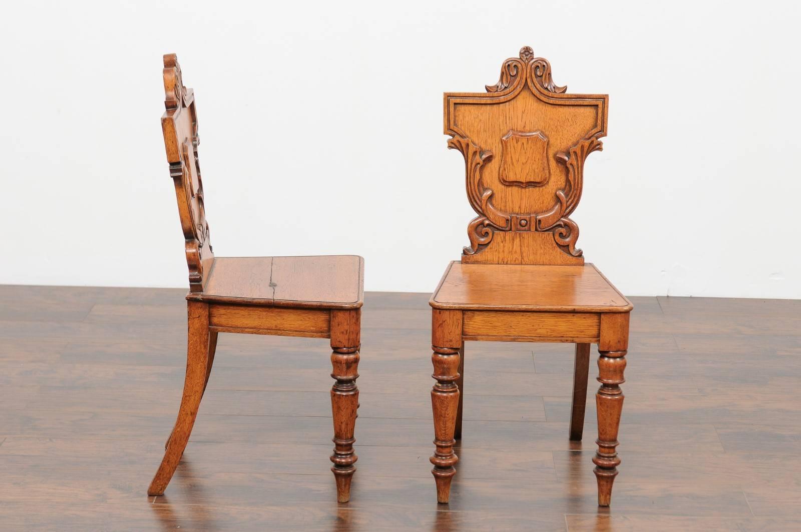 Wood Pair of English Oak Hall Chairs with Carved Shield Backs and Cartouches, 1890s