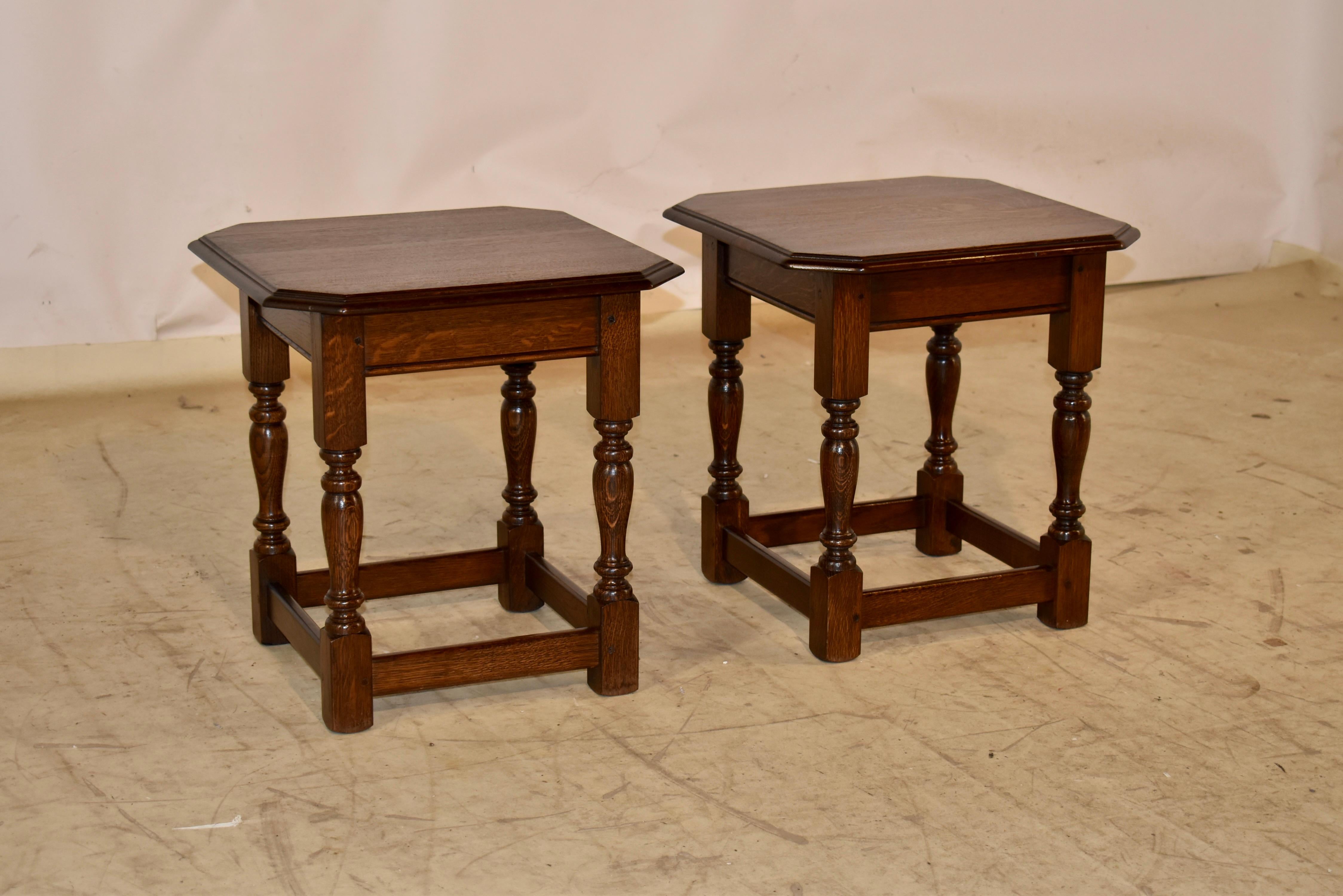 Pair of lovely oak side tables from England, circa 1900.  

The tops have nice graining and molded and beveled edges, following down to simple aprons with routed lower edges and supported on hand turned legs, joined by simple stretchers.

The tables