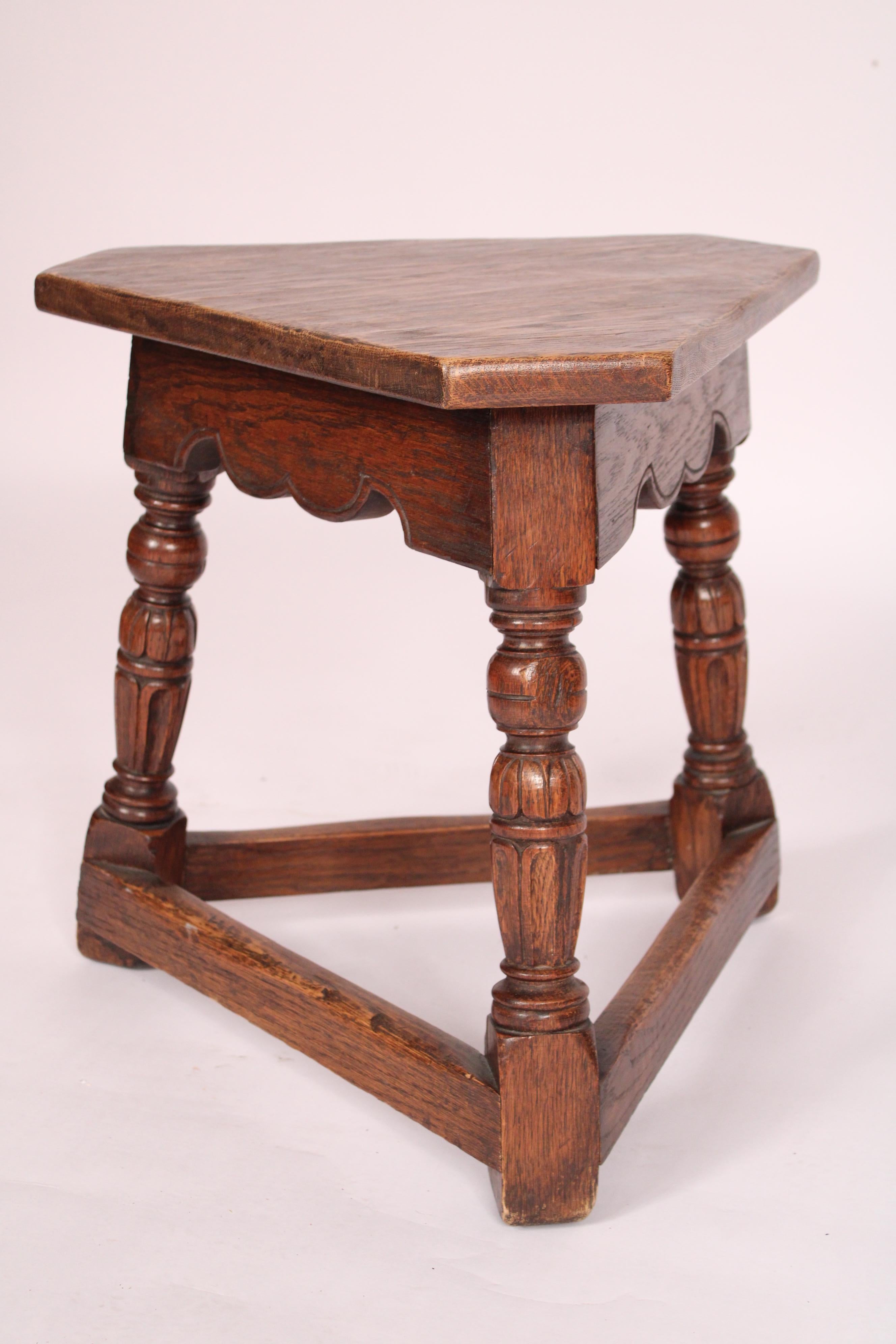 Pair of William & Mary style oak joint stools, made by Marshall Laird, circa 1930's. With triangular shaped tops, 3 turned supports, with stretcher bars joining supports. Made by Pasadena, California furniture maker Marshall Laird. He designed and