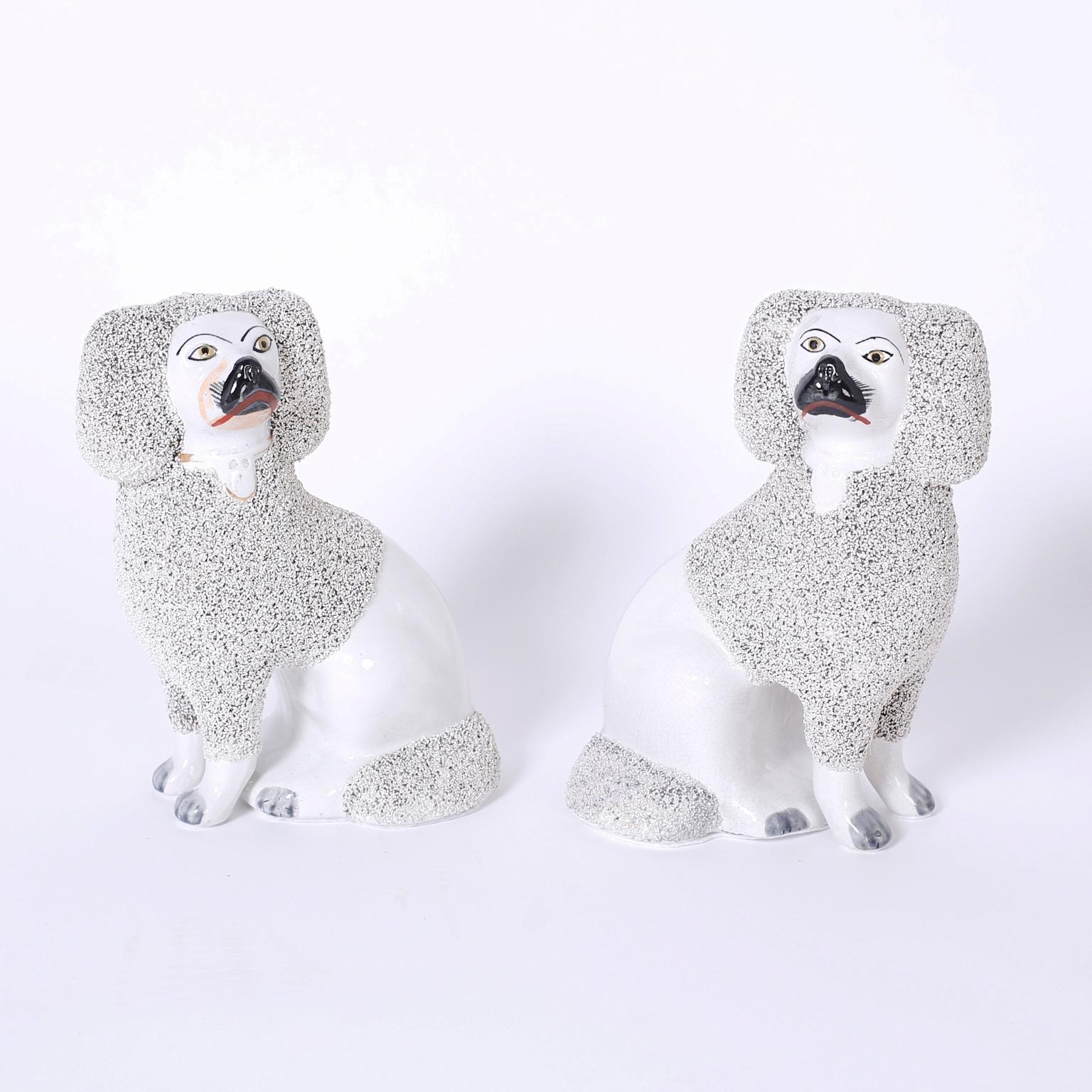 Antique pair of Staffordshire poodles cast in a press mold with English clay and in remarkable condition.