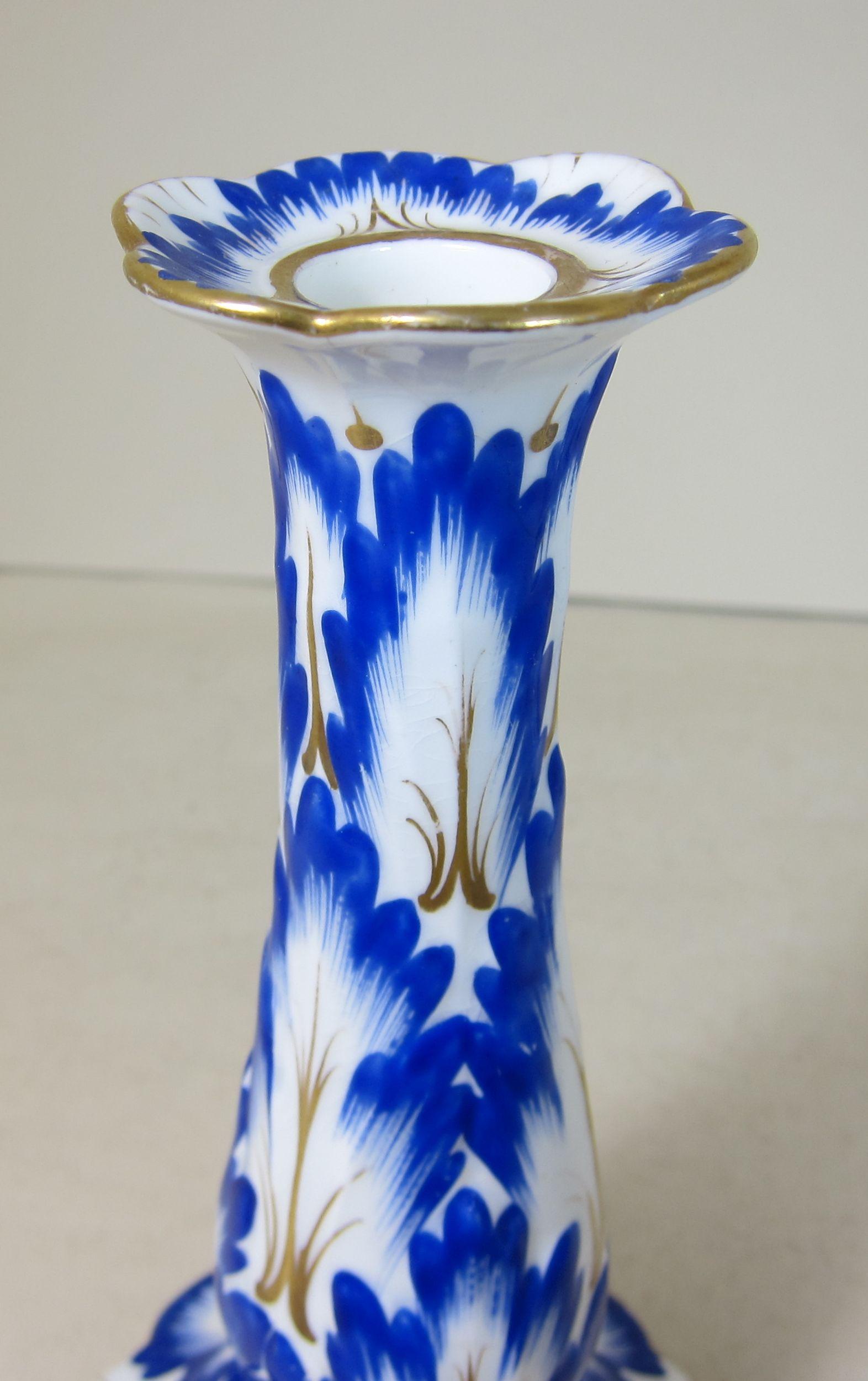 Early 19th Century Pair of English Porcelain Candlesticks Decorated with Blue and Gilt Leaves
