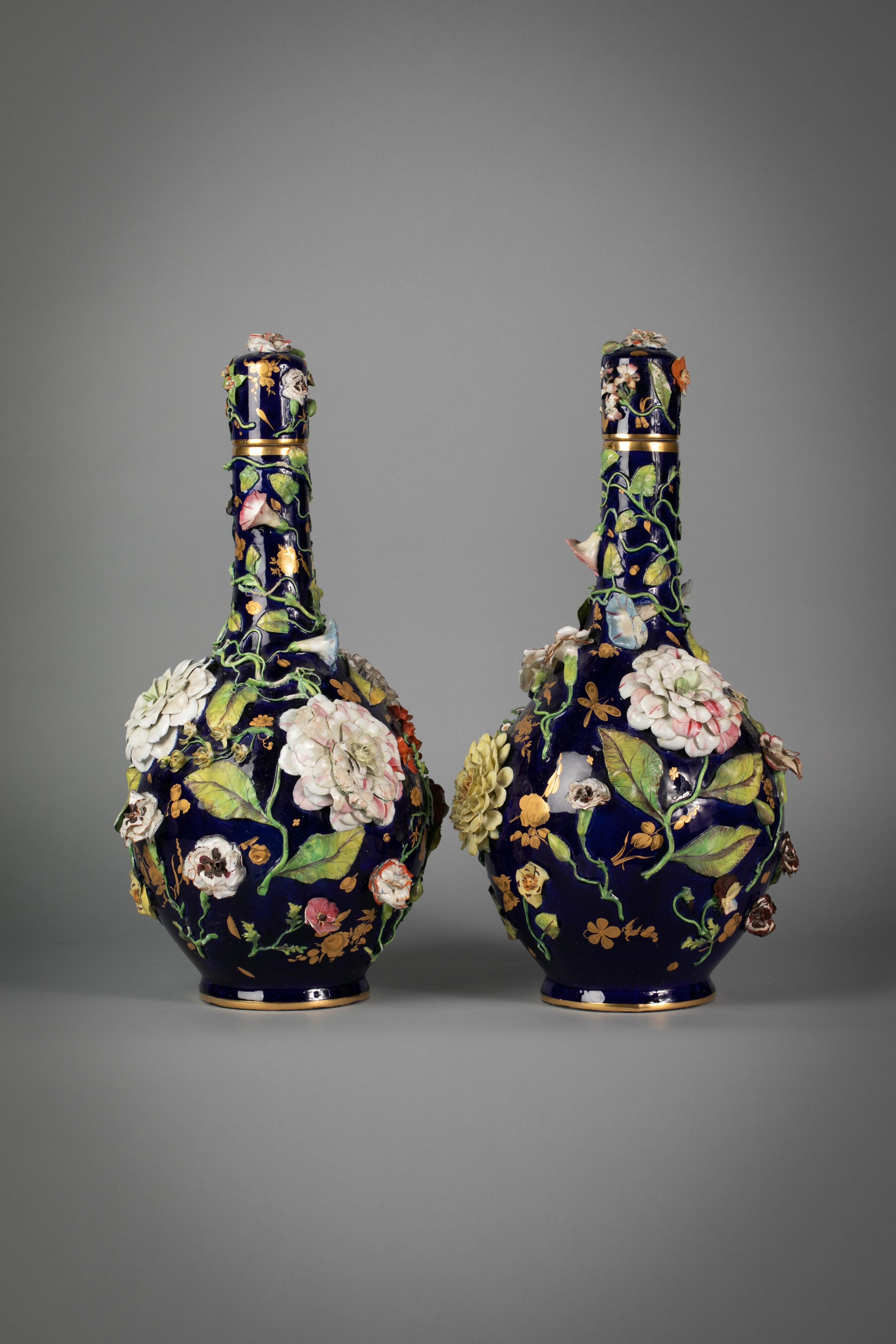 Pair of English porcelain floral covered vases, circa 1840.