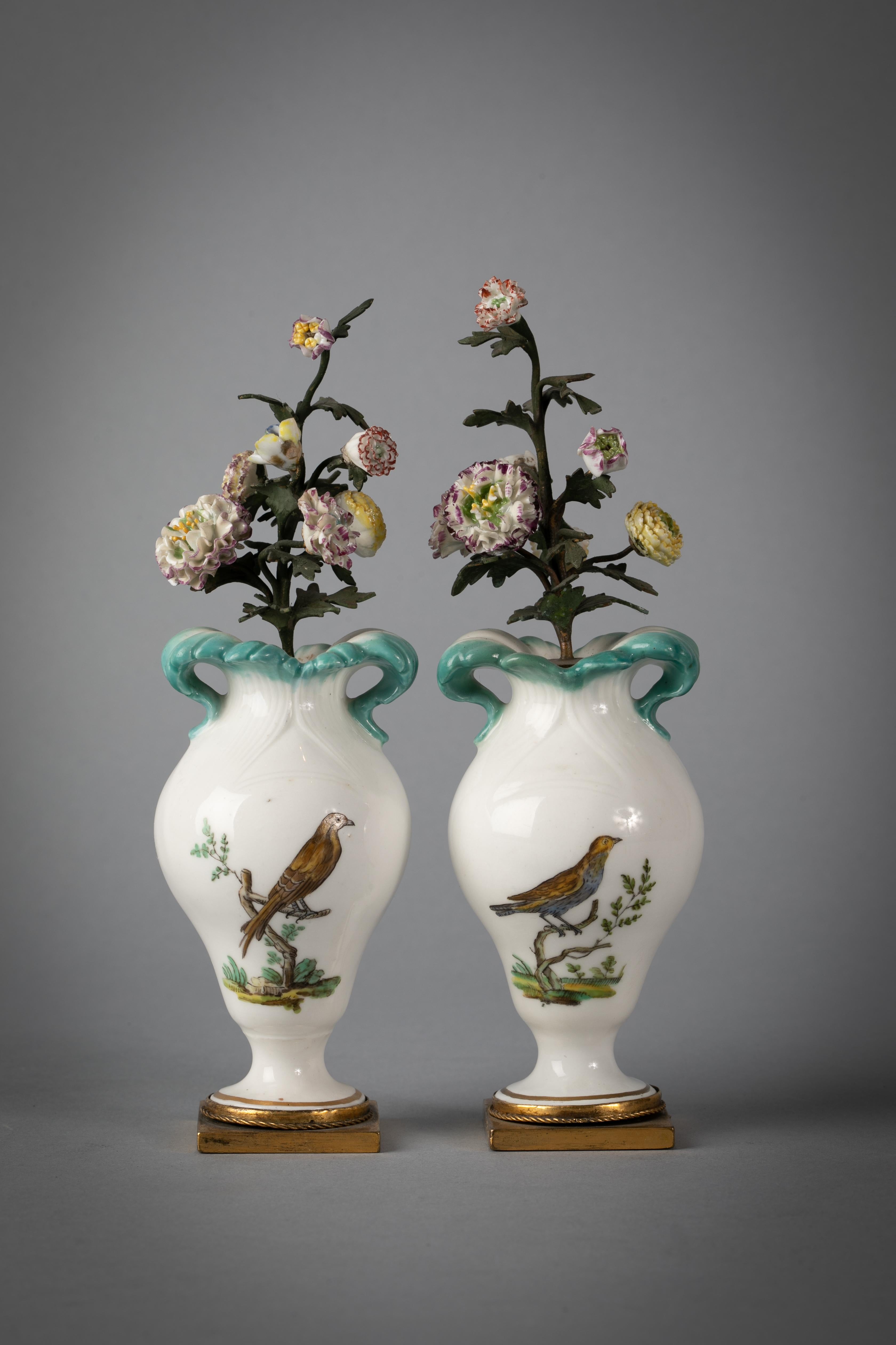 With floral inserts on gilt bronze base. In Sevres-style painted on either side with birds perched on branches.