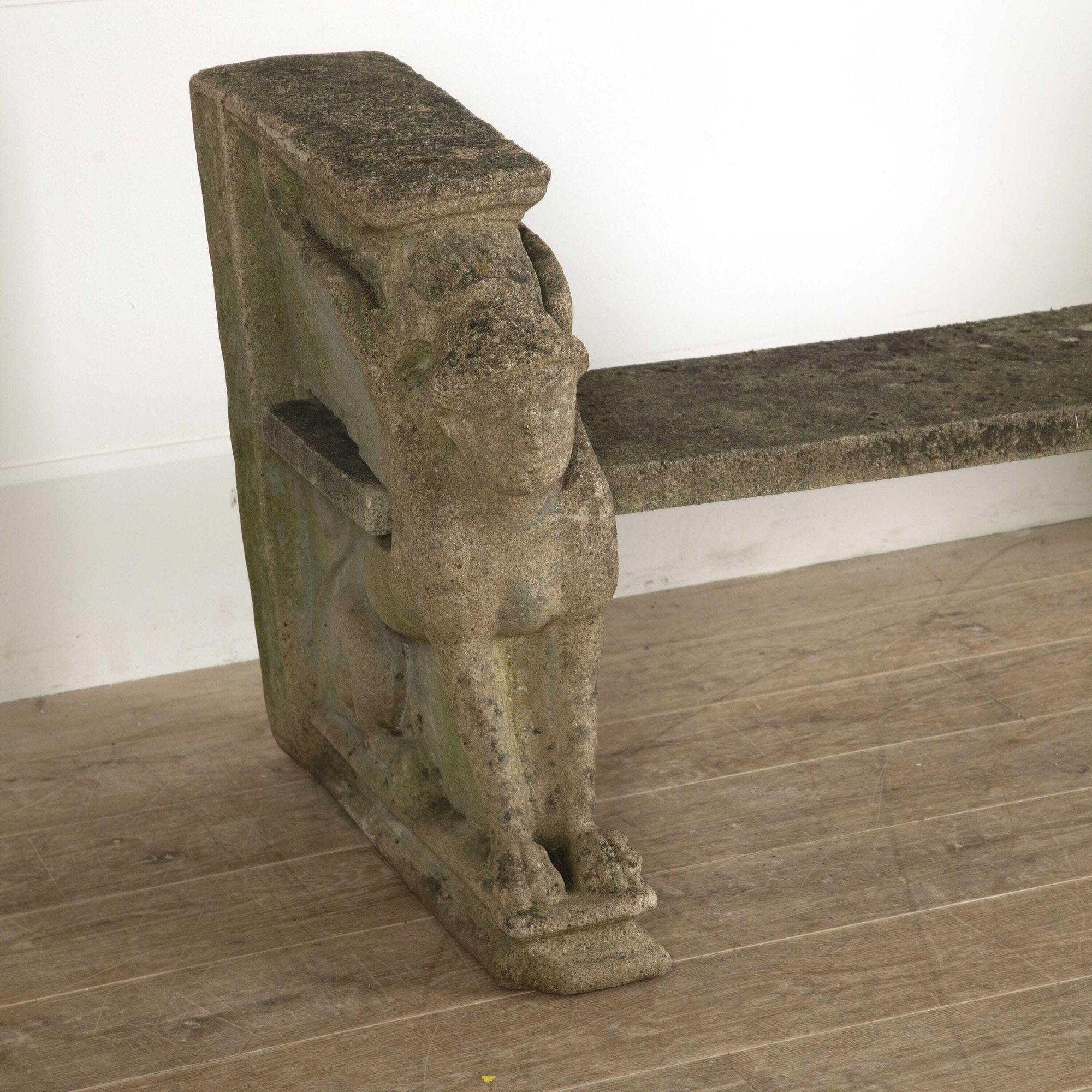 Rare and impressive pair of English reconstituted stone garden benches. Featuring winged male Sphinx end supports and foliate decoration to the backs and sides.