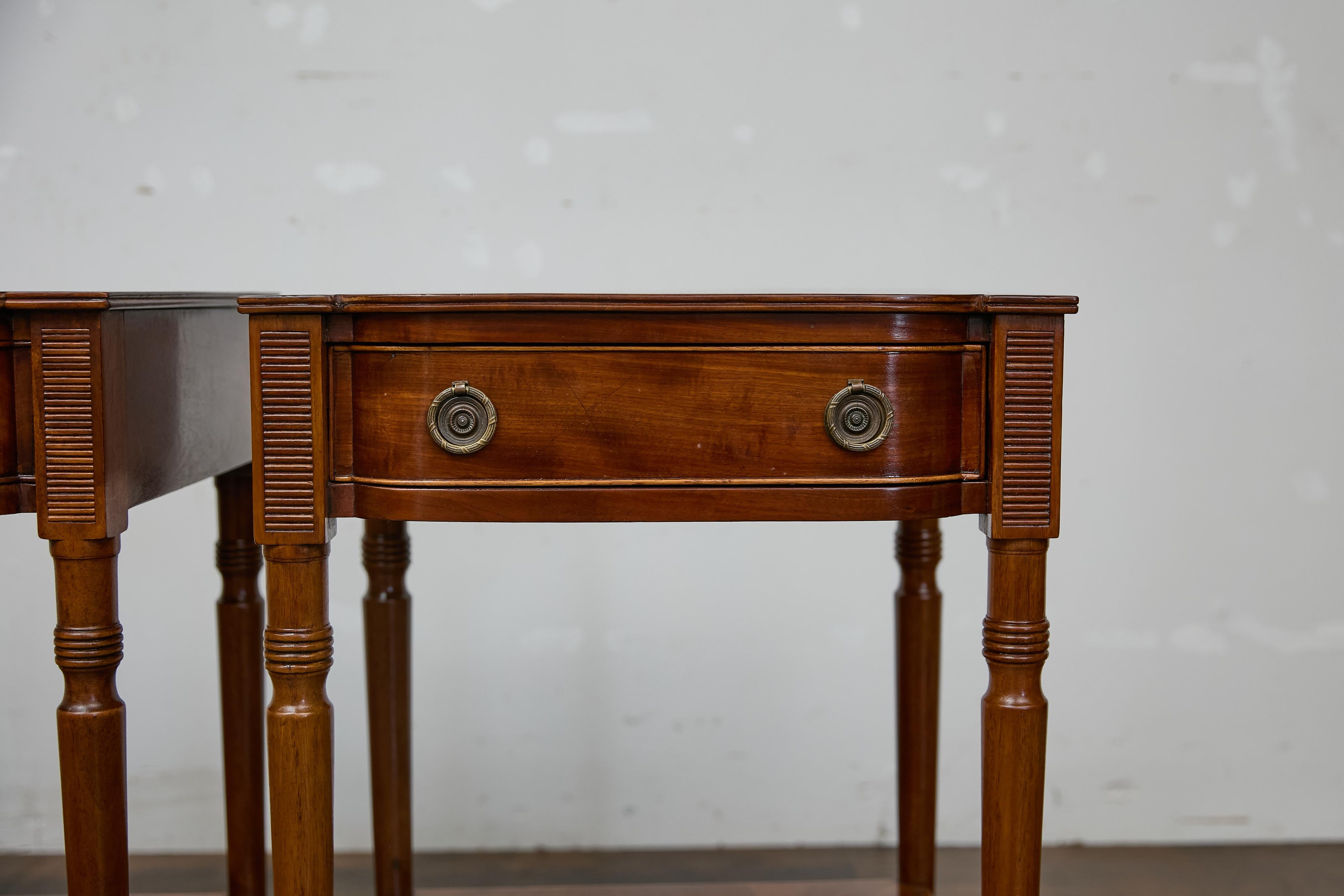 Pareja de mesas auxiliares inglesas de caoba, estilo Regencia, del siglo XIX, con tableros de chapa de madera a juego y cajones sencillos. Este elegante par de mesas auxiliares inglesas de caoba encarna la refinada sencillez del estilo Regencia,