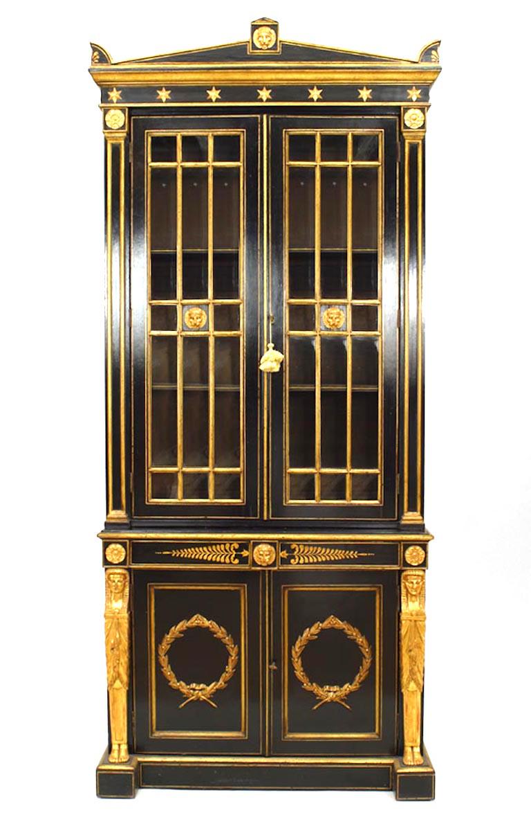 Pair of early 19th century English Regency black lacquered and gilt trimmed bookcase cabinets with two upper gilt mullioned glass doors over lower doors mounted with gilt wreaths.