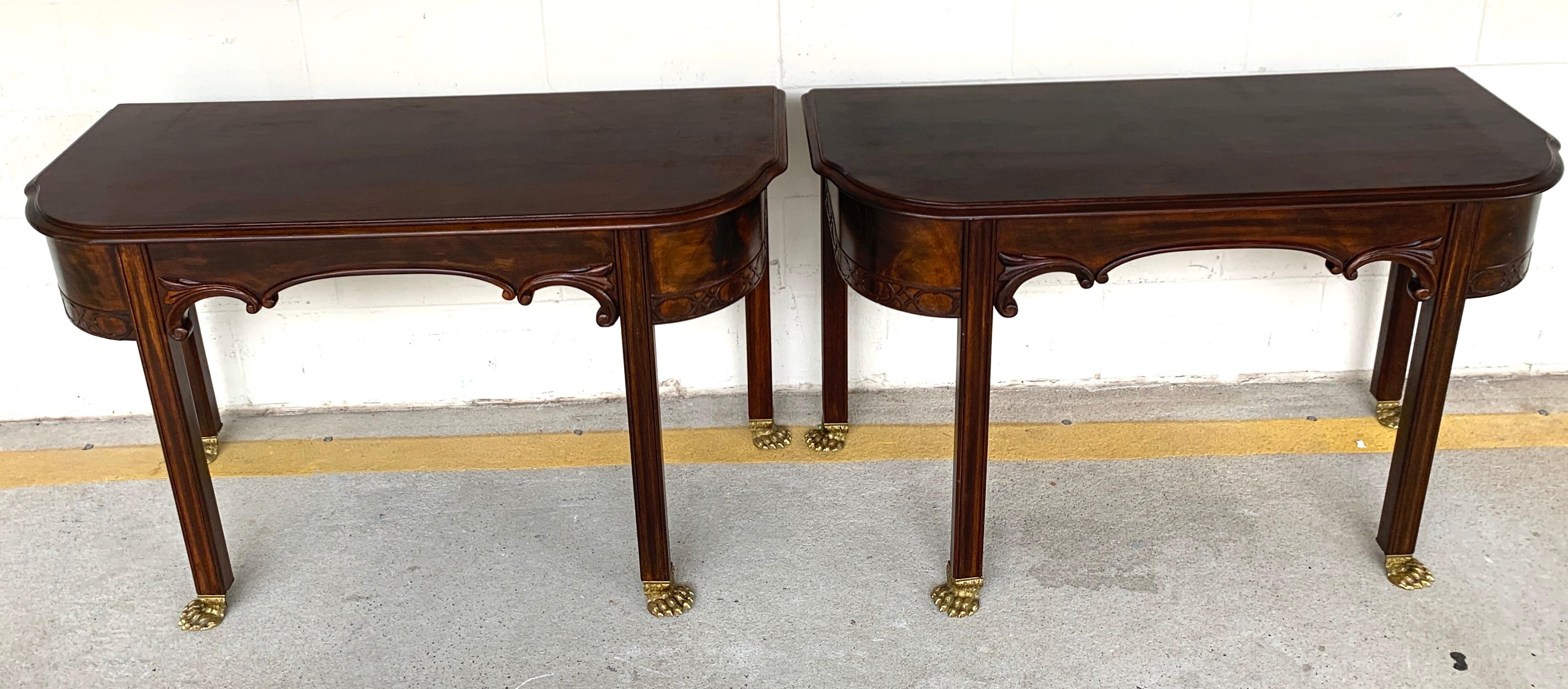 Pair of English Regency brass footed console tables, Each one of rectangular form, with scalloped front aprons, raised on four column legs with finely cast brass paw feet.
Each console is 44-Inches wide x 18-Inches deep x 26.5 -Inches high

pair