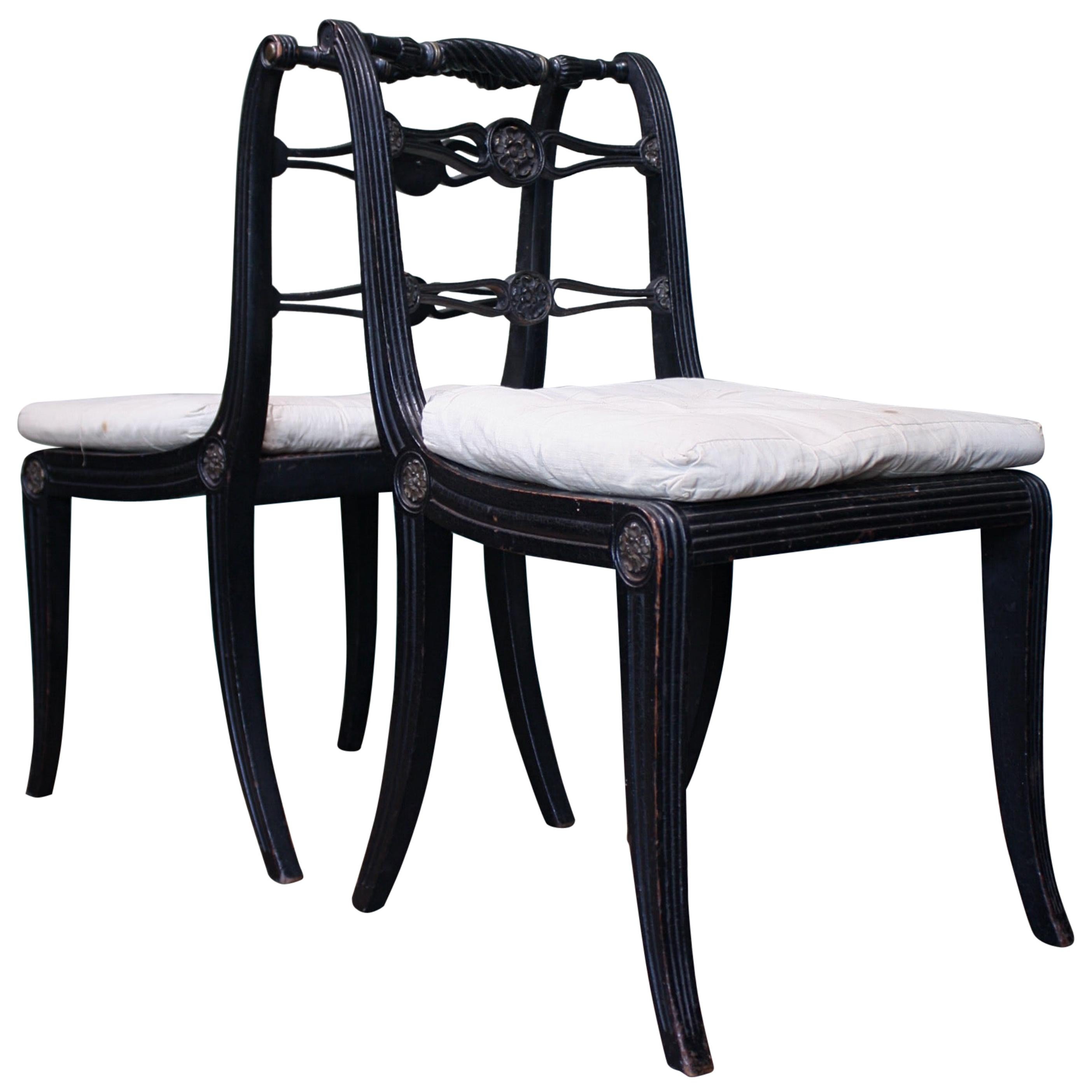 Pair of English Regency Ebonised Caned Klismos Side Chairs with Original Squabs