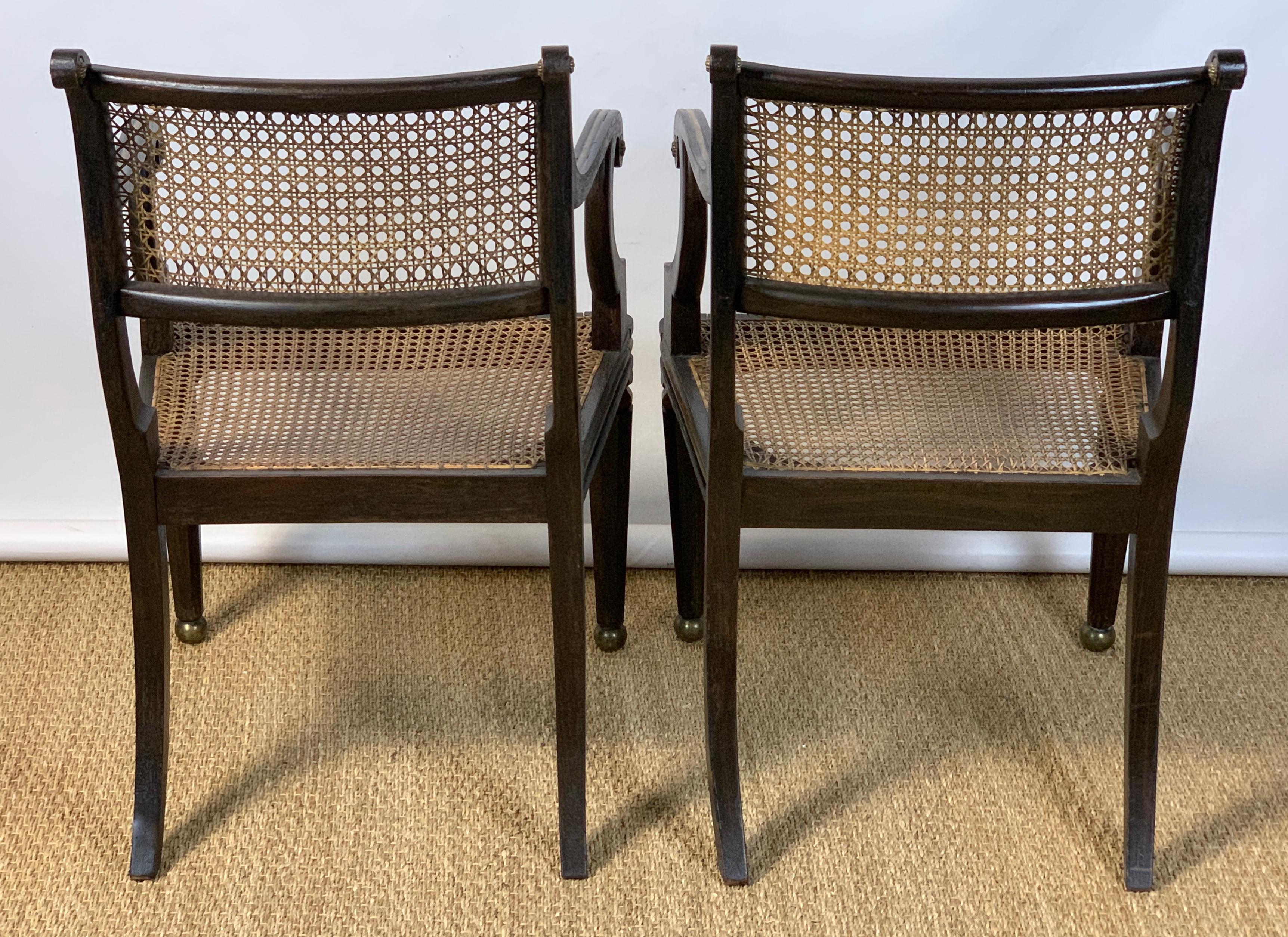 19th Century Pair of English Regency Ebonized and Gilded Armchairs