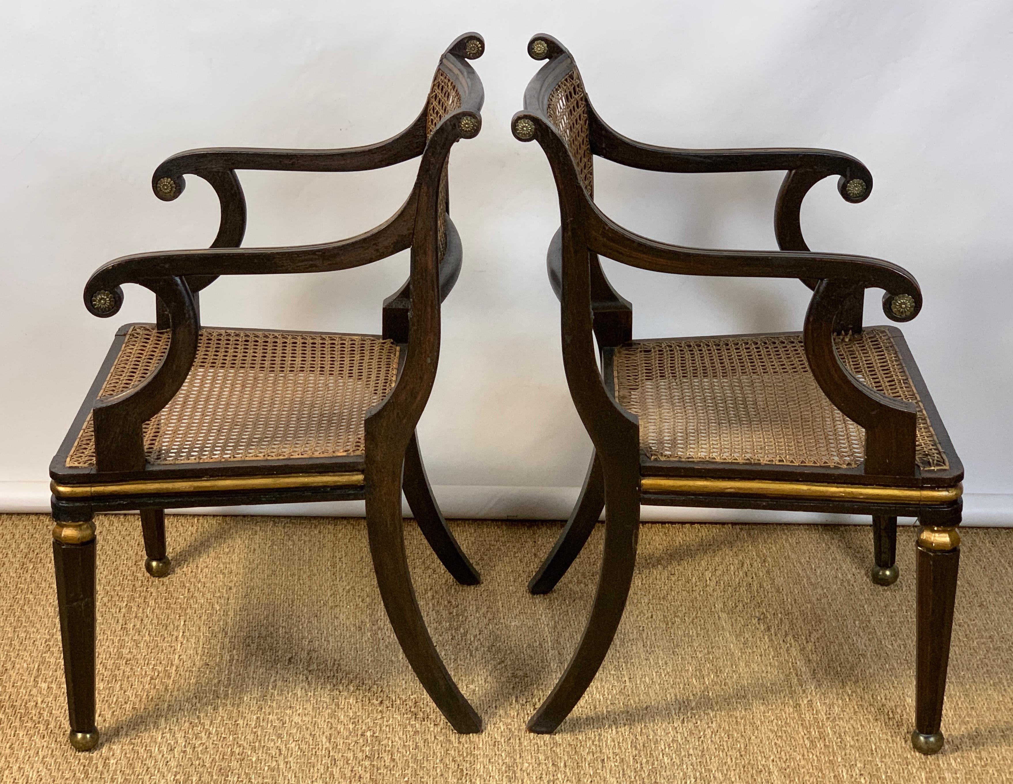 Wood Pair of English Regency Ebonized and Gilded Armchairs