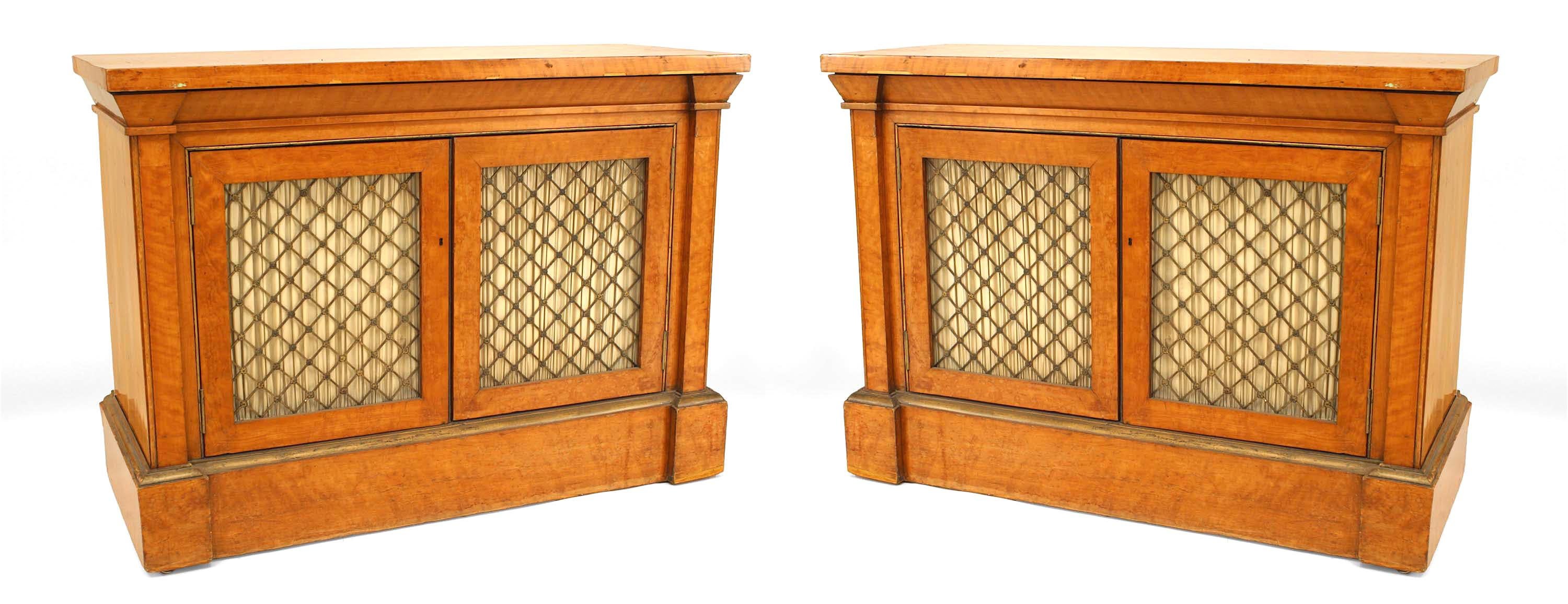 Pair of English Regency (circa 1820) gilt metal mounted satinwood side cabinets with 2 grilled doors above a plinth base (in the style of SHERATON) (PRICED AS Pair).
