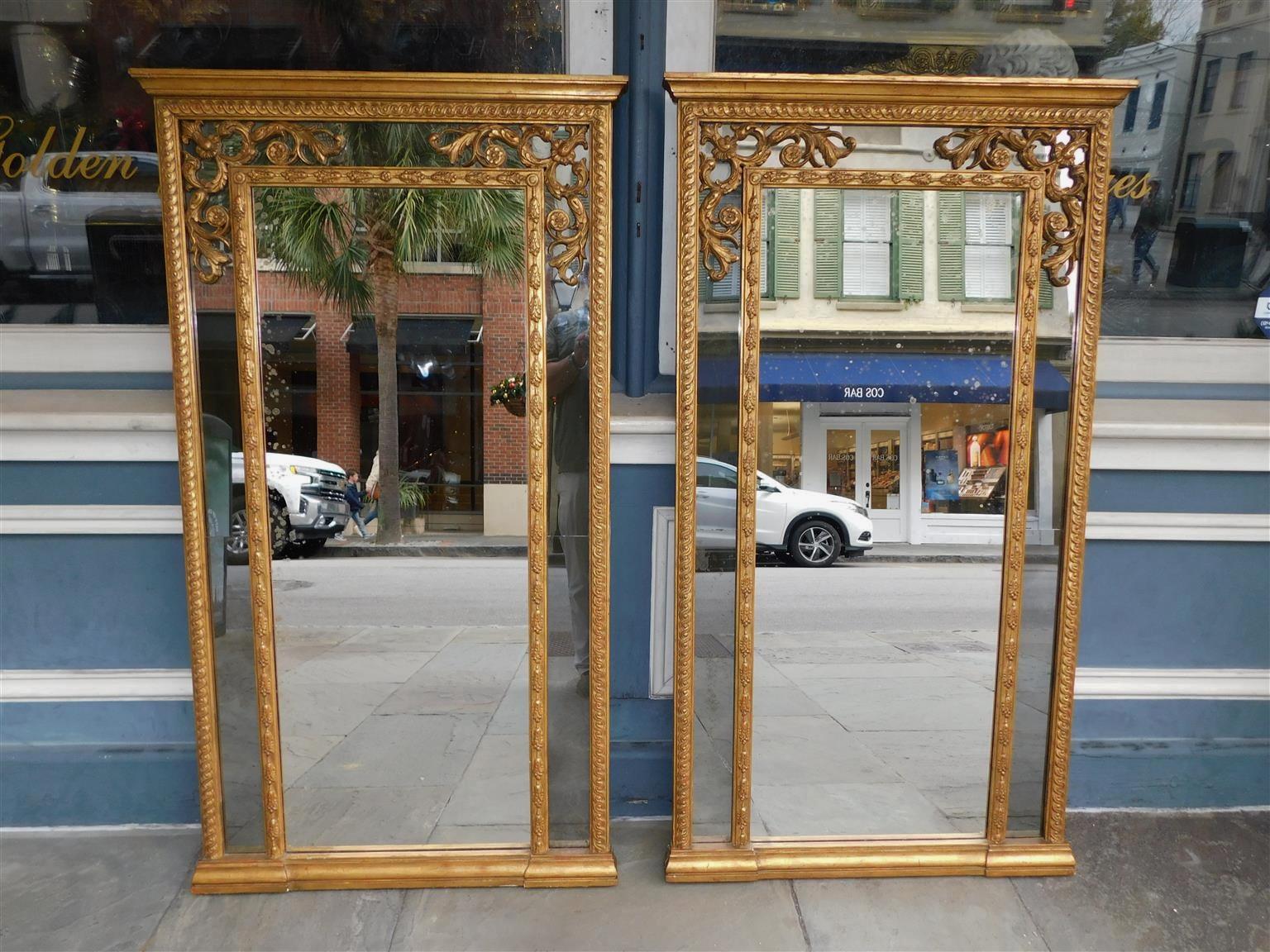 Pair of English Regency gilt wood and gesso articulated carved foliage wall mirrors. Mirrors retain the original glass and wood backing. Early 19th century.