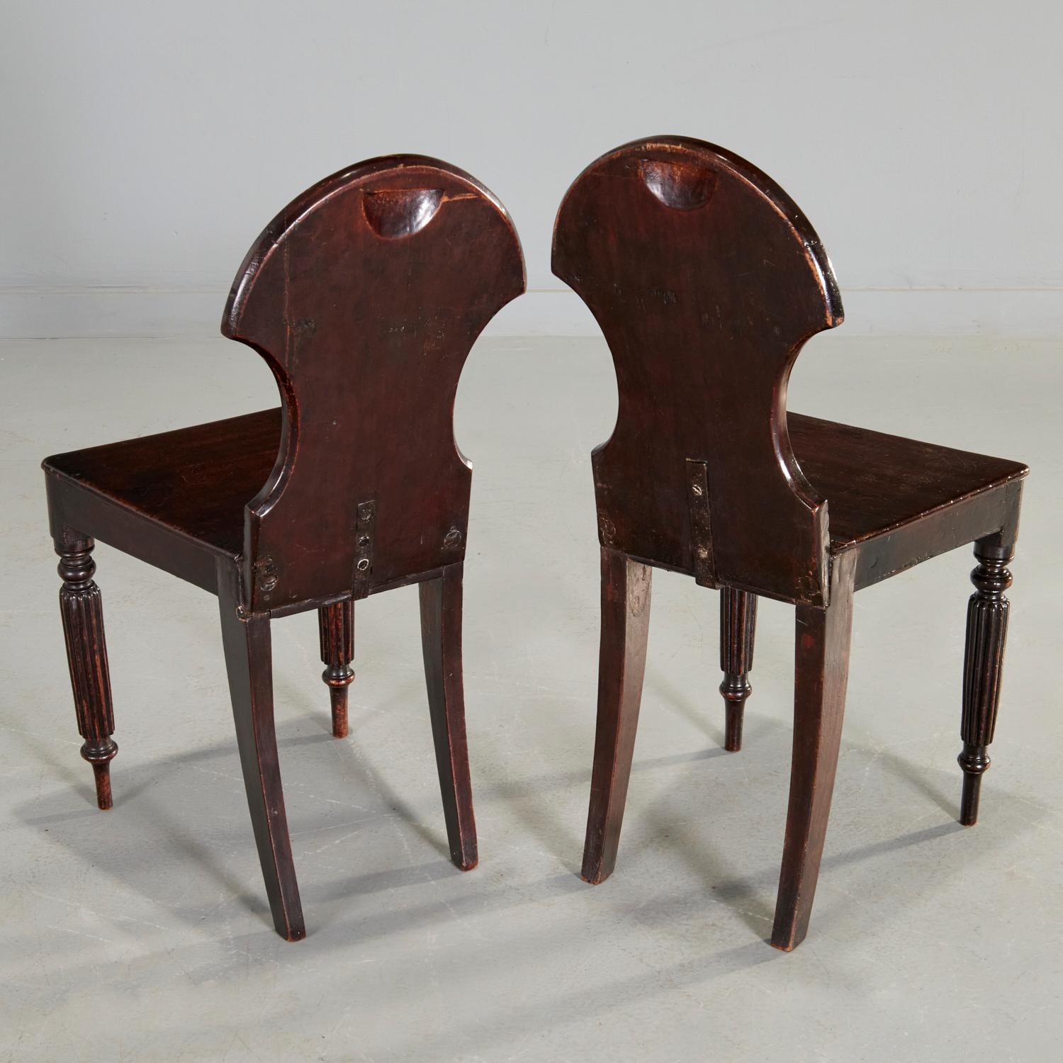 Hand-Carved Pair of English Regency Mahogany Hall Chairs For Sale