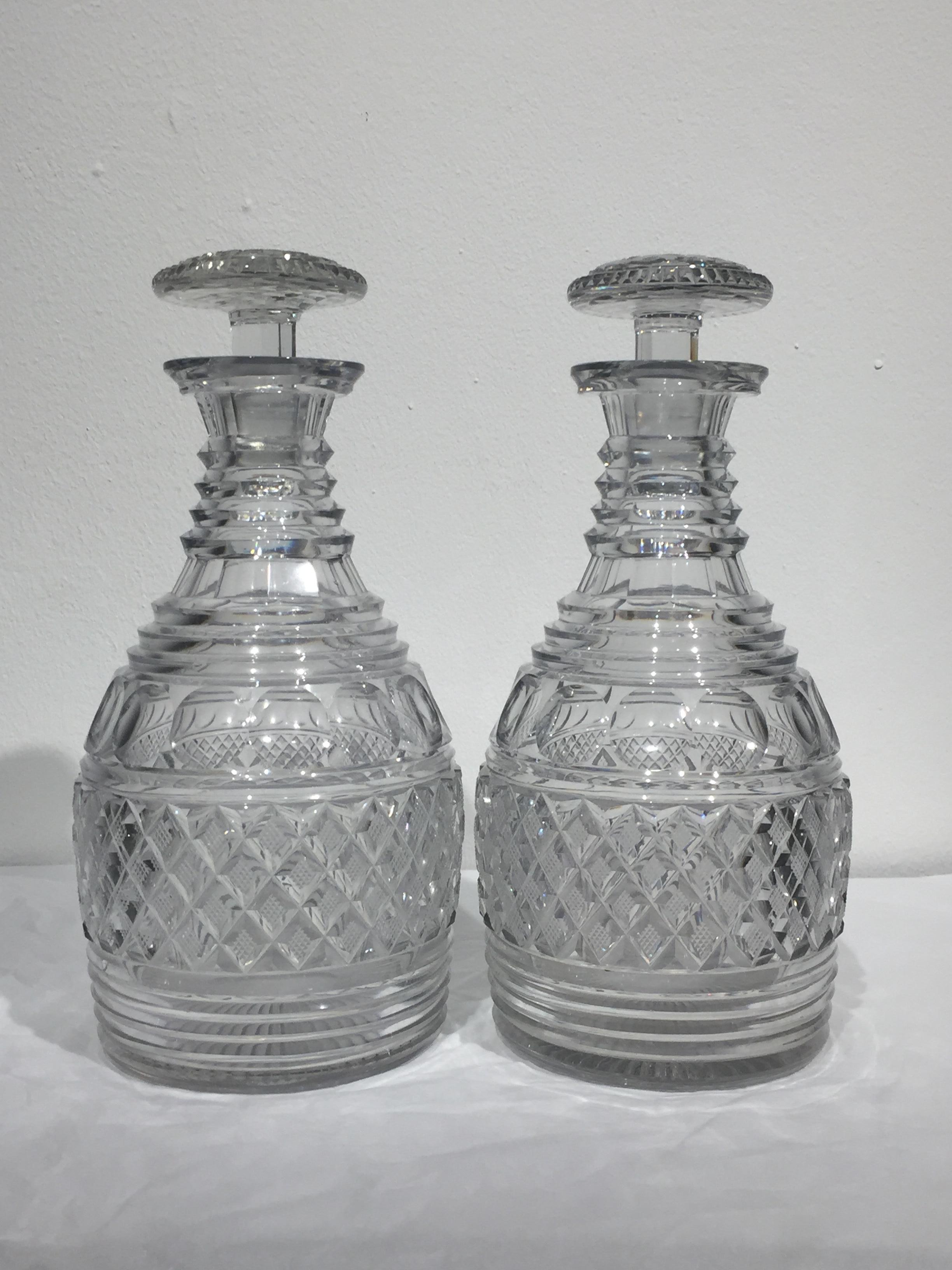 A superb pair of English Regency period cut crystal decanters of the finest quality retaining their original stoppers.
The stoppers with hobnail centres and cross cut edges over faceted stems, the decanters with step rings, panels, facet cut