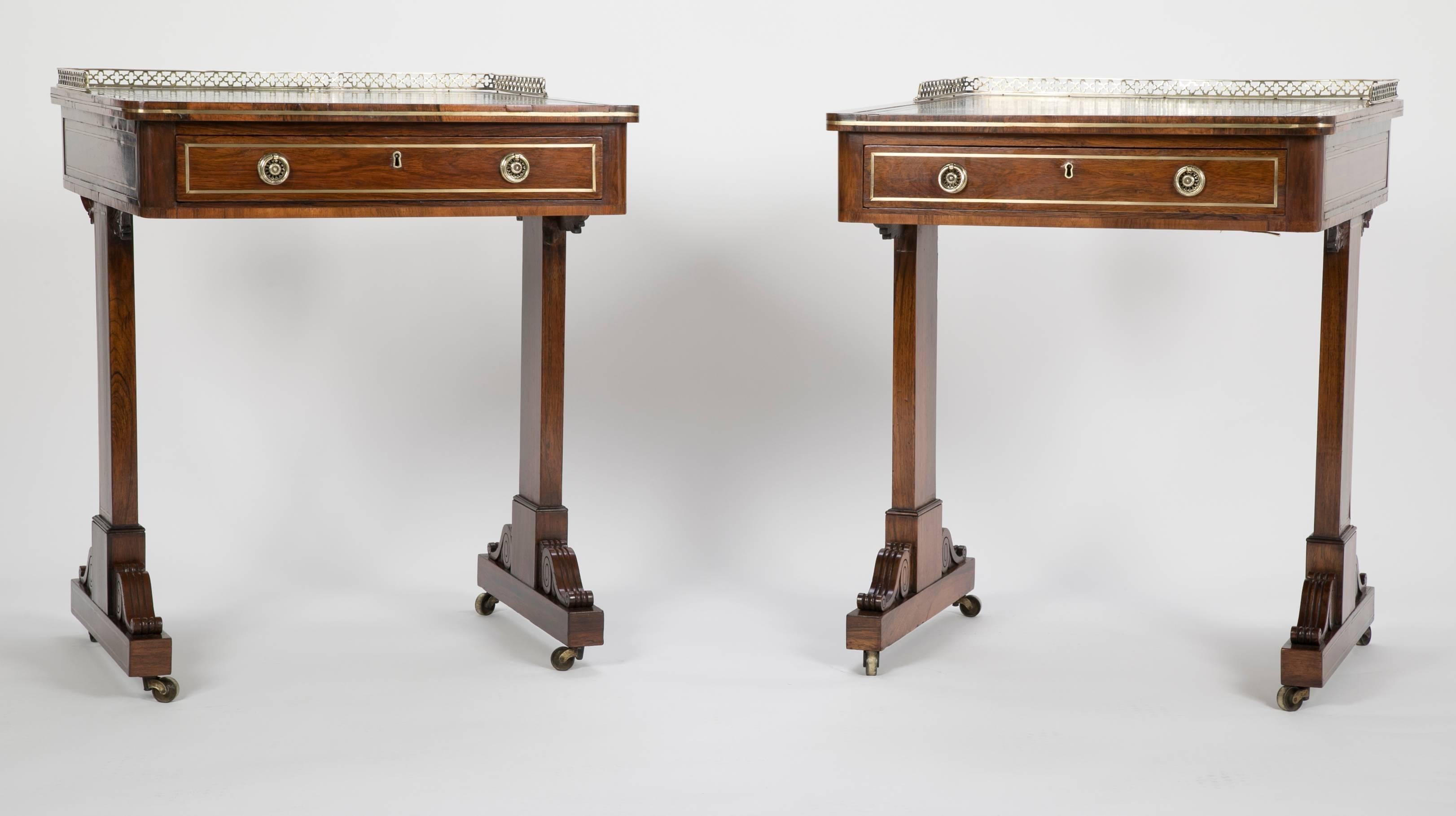 Pair of English Regency period rosewood writing tables with gold tooled green leather tops. The pair were most likely formerly used as school desks for privately educated students.