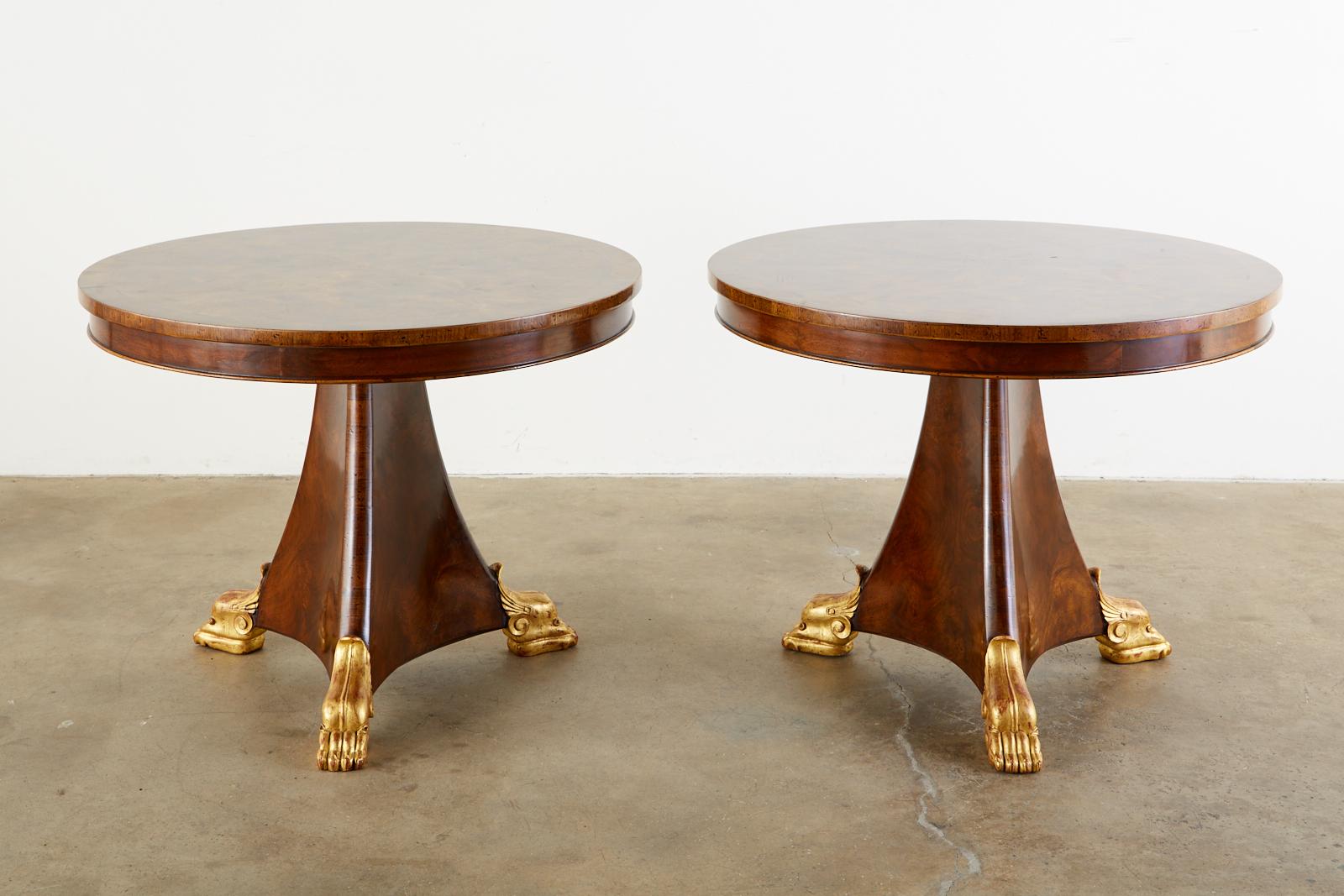 Fine matched pair of English Regency style pedestal tables. Featuring a dramatic burl veneer top. The round tables could serve as center tables, dining tables, or library tables with a 28 inch height. The triangular pedestal flares out on the end