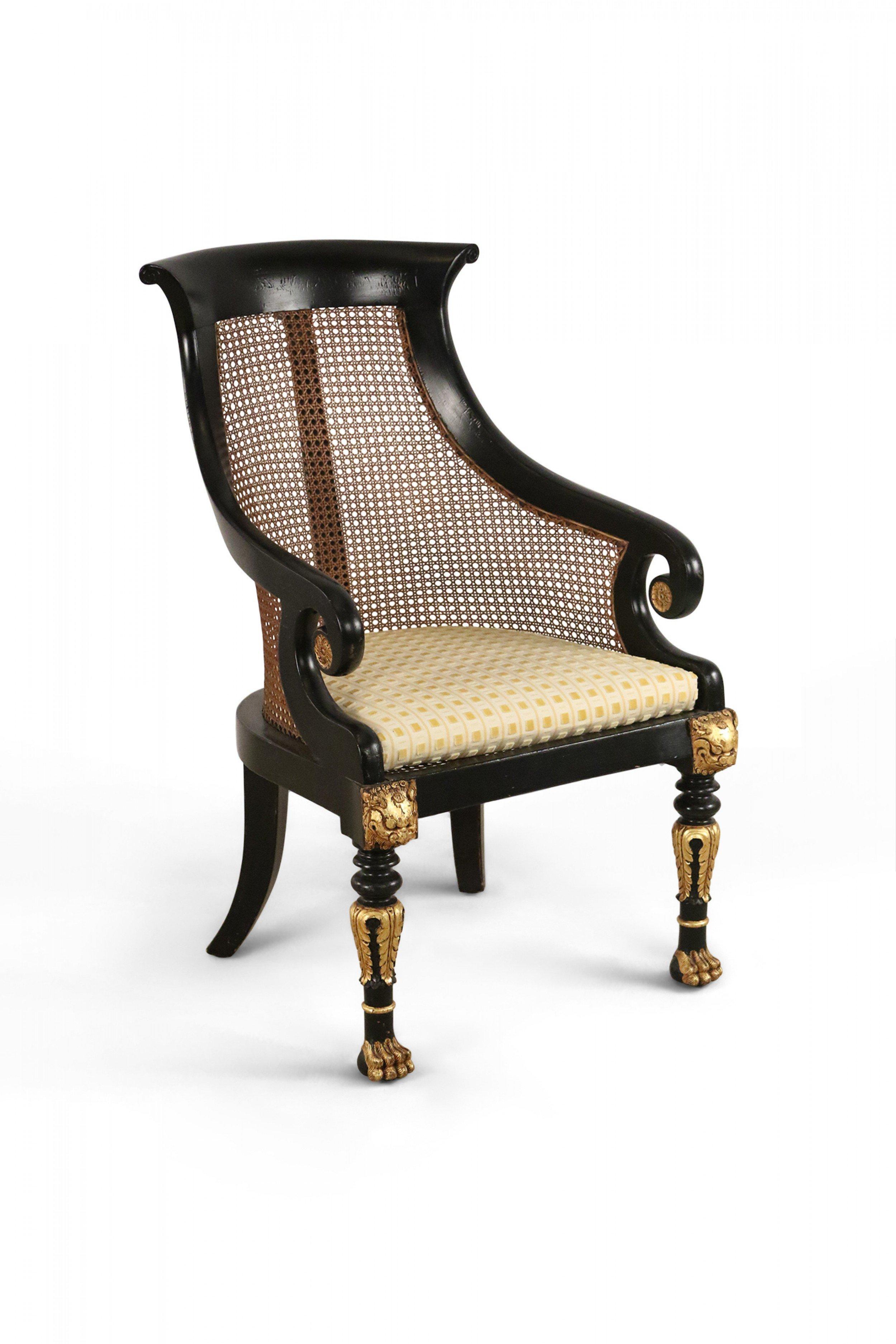 20th Century Pair of English Regency Style Carved Black and Gilt Cane Back Armchairs For Sale