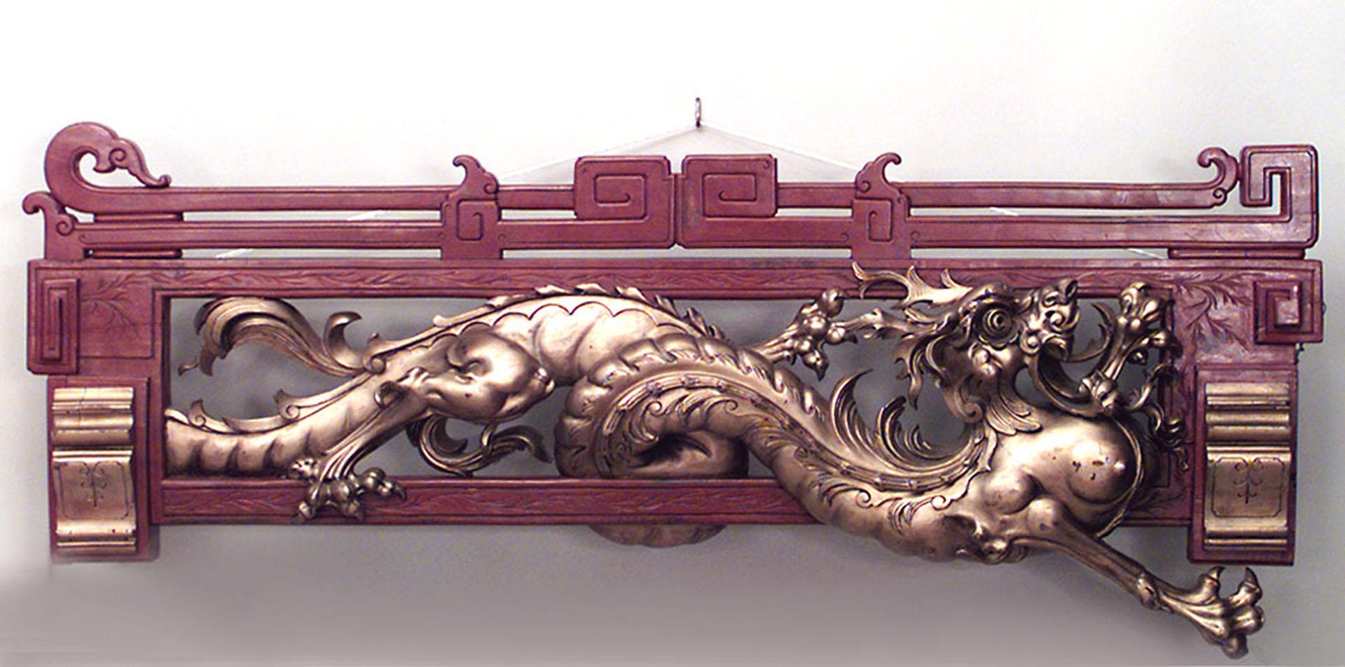 Pair of English Regency style (19th Century) red and gold painted horizontal dragon wall plaques (PRICED AS Pair).

